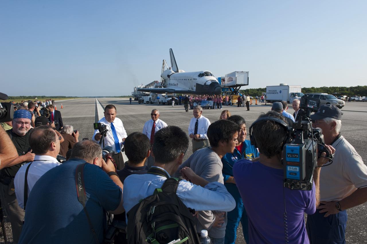 CAPE CANAVERAL, Fla. -- On the Shuttle Landing Facility runway  at NASA's Kennedy Space Center in Florida, media interview NASA Administrator Charlie Bolden and Kennedy Space Center Director Bob Cabana after space shuttle Atlantis' landing and final return from space at 5:57 a.m. EDT July 21, 2011.             Securing the space shuttle fleet's place in history, Atlantis marks the 26th nighttime landing of NASA's Space Shuttle Program and the 78th landing at Kennedy. Atlantis and its crew delivered to the International Space Station the Raffaello multi-purpose logistics module packed with more than 9,400 pounds of spare parts, equipment and supplies that will sustain station operations for the next year. STS-135 is the 33rd and final flight for Atlantis and the final mission of the Space Shuttle Program. For more information, visit www.nasa.gov/mission_pages/shuttle/shuttlemissions/sts135/index.html. Photo credit: NASA/Kim Shiflett