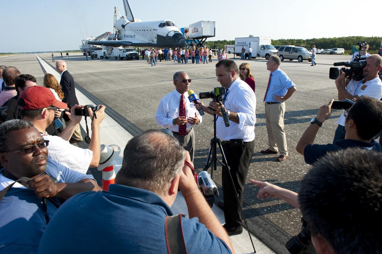 CAPE CANAVERAL, Fla. -- On the Shuttle Landing Facility runway  at NASA's Kennedy Space Center in Florida, media interview NASA Administrator Charlie Bolden after space shuttle Atlantis' landing and final return from space at 5:57 a.m. EDT July 21, 2011.           Securing the space shuttle fleet's place in history, Atlantis marks the 26th nighttime landing of NASA's Space Shuttle Program and the 78th landing at Kennedy. Atlantis and its crew delivered to the International Space Station the Raffaello multi-purpose logistics module packed with more than 9,400 pounds of spare parts, equipment and supplies that will sustain station operations for the next year. STS-135 is the 33rd and final flight for Atlantis and the final mission of the Space Shuttle Program. For more information, visit www.nasa.gov/mission_pages/shuttle/shuttlemissions/sts135/index.html. Photo credit: NASA/Kim Shiflett
