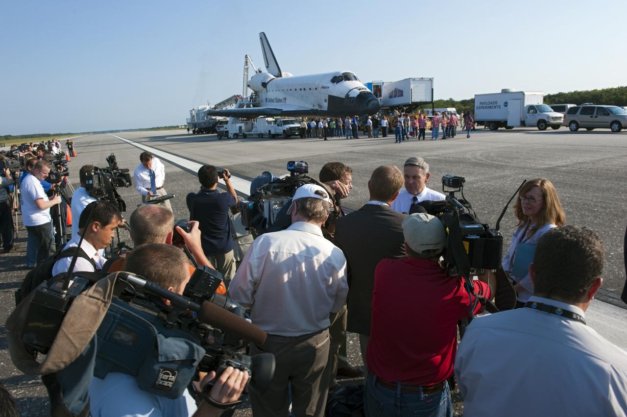 CAPE CANAVERAL, Fla. -- On the Shuttle Landing Facility runway  at NASA's Kennedy Space Center in Florida, media interview Kennedy Center Director Bob Cabana after space shuttle Atlantis' landing and final return from space at 5:57 a.m. EDT July 21, 2011.         Securing the space shuttle fleet's place in history, Atlantis marks the 26th nighttime landing of NASA's Space Shuttle Program and the 78th landing at Kennedy. Atlantis and its crew delivered to the International Space Station the Raffaello multi-purpose logistics module packed with more than 9,400 pounds of spare parts, equipment and supplies that will sustain station operations for the next year. STS-135 is the 33rd and final flight for Atlantis and the final mission of the Space Shuttle Program. For more information, visit www.nasa.gov/mission_pages/shuttle/shuttlemissions/sts135/index.html. Photo credit: NASA/Kim Shiflett