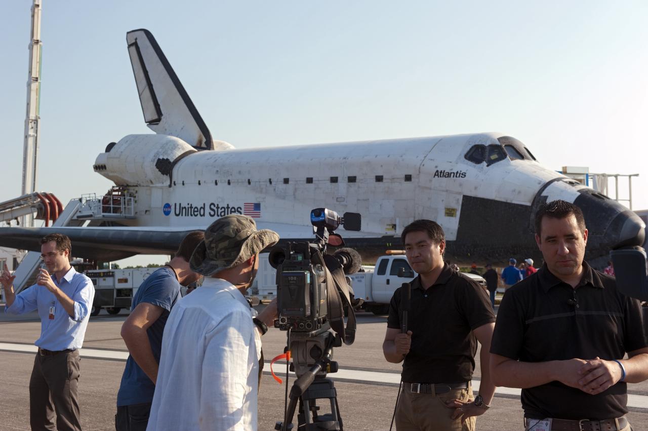 CAPE CANAVERAL, Fla. -- On the Shuttle Landing Facility runway  at NASA's Kennedy Space Center in Florida, media photograph space shuttle Atlantis after its landing and final return from space at 5:57 a.m. EDT July 21, 2011.       Securing the space shuttle fleet's place in history, Atlantis marks the 26th nighttime landing of NASA's Space Shuttle Program and the 78th landing at Kennedy. Atlantis and its crew delivered to the International Space Station the Raffaello multi-purpose logistics module packed with more than 9,400 pounds of spare parts, equipment and supplies that will sustain station operations for the next year. STS-135 is the 33rd and final flight for Atlantis and the final mission of the Space Shuttle Program. For more information, visit www.nasa.gov/mission_pages/shuttle/shuttlemissions/sts135/index.html. Photo credit: NASA/Kim Shiflett