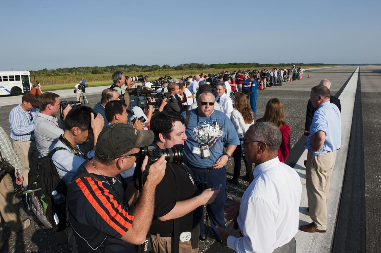 CAPE CANAVERAL, Fla. -- On the Shuttle Landing Facility runway  at NASA's Kennedy Space Center in Florida, media interview NASA Administrator Charlie Bolden after space shuttle Atlantis' landing and final return from space at 5:57 a.m. EDT July 21, 2011.         Securing the space shuttle fleet's place in history, Atlantis marks the 26th nighttime landing of NASA's Space Shuttle Program and the 78th landing at Kennedy. Atlantis and its crew delivered to the International Space Station the Raffaello multi-purpose logistics module packed with more than 9,400 pounds of spare parts, equipment and supplies that will sustain station operations for the next year. STS-135 is the 33rd and final flight for Atlantis and the final mission of the Space Shuttle Program. For more information, visit www.nasa.gov/mission_pages/shuttle/shuttlemissions/sts135/index.html. Photo credit: NASA/Kim Shiflett
