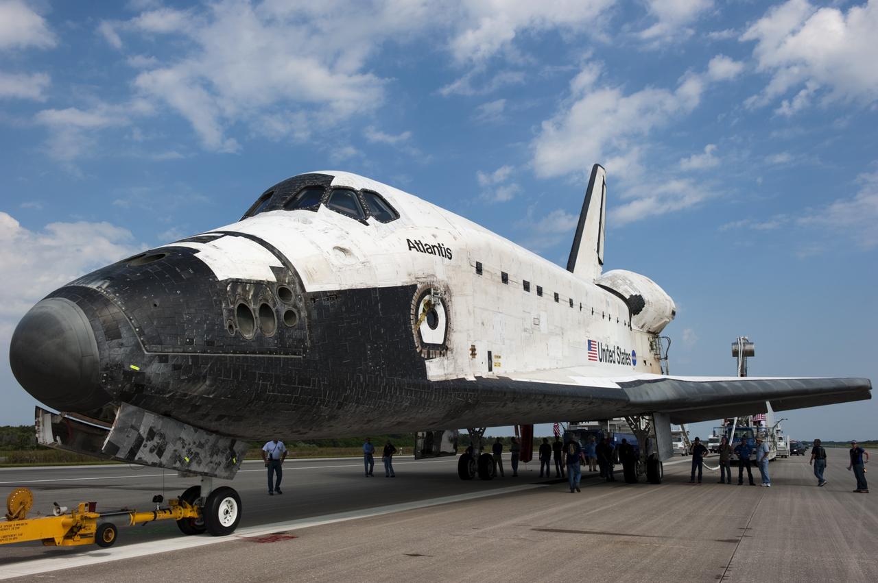 CAPE CANAVERAL, Fla. -- Workers prepare space shuttle Atlantis for its trek from the Shuttle Landing Facility to Orbiter Processing Facility-2 for the last time. Atlantis' final return to Earth on Runway 15 at NASA's Kennedy Space Center in Florida occurred at 5:57 a.m. EDT July 21, 2011.               Securing the space shuttle fleet's place in history, Atlantis marks the 26th nighttime landing of NASA's Space Shuttle Program and the 78th landing at Kennedy. Atlantis and its crew delivered to the International Space Station the Raffaello multi-purpose logistics module packed with more than 9,400 pounds of spare parts, equipment and supplies that will sustain station operations for the next year. STS-135 is the 33rd and final flight for Atlantis and the final mission of the Space Shuttle Program. For more information, visit www.nasa.gov/mission_pages/shuttle/shuttlemissions/sts135/index.html. Photo credit: NASA/Kim Shiflett