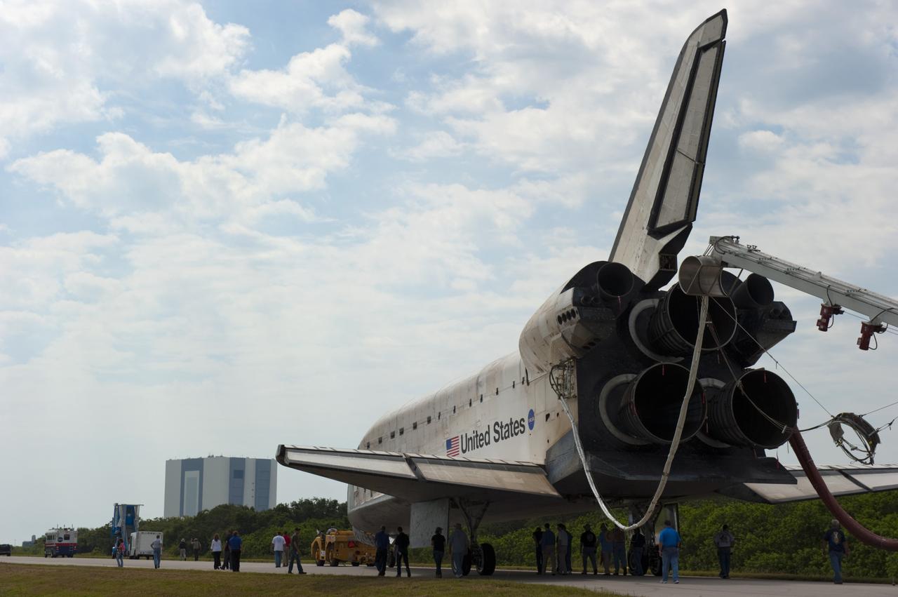 CAPE CANAVERAL, Fla. -- Workers accompany space shuttle Atlantis as it makes its slow trek from the Shuttle Landing Facility to Orbiter Processing Facility-2 for the last time. Atlantis' final return to Earth on Runway 15 at NASA's Kennedy Space Center in Florida occurred at 5:57 a.m. EDT July 21, 2011.                 Securing the space shuttle fleet's place in history, Atlantis marks the 26th nighttime landing of NASA's Space Shuttle Program and the 78th landing at Kennedy. Atlantis and its crew delivered to the International Space Station the Raffaello multi-purpose logistics module packed with more than 9,400 pounds of spare parts, equipment and supplies that will sustain station operations for the next year. STS-135 is the 33rd and final flight for Atlantis and the final mission of the Space Shuttle Program. For more information, visit www.nasa.gov/mission_pages/shuttle/shuttlemissions/sts135/index.html. Photo credit: NASA/Kim Shiflett