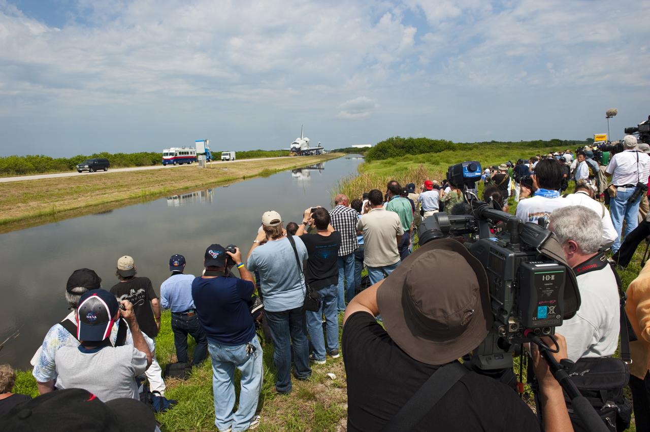 CAPE CANAVERAL, Fla. -- Media photograph space shuttle Atlantis as it is slowly towed from the Shuttle Landing Facility runway to Orbiter Processing Facility-2 for the last time. Atlantis' final return to Earth on Runway 15 at NASA's Kennedy Space Center in Florida occurred at 5:57 a.m. EDT July 21, 2011.                 Securing the space shuttle fleet's place in history, Atlantis marks the 26th nighttime landing of NASA's Space Shuttle Program and the 78th landing at Kennedy. Atlantis and its crew delivered to the International Space Station the Raffaello multi-purpose logistics module packed with more than 9,400 pounds of spare parts, equipment and supplies that will sustain station operations for the next year. STS-135 is the 33rd and final flight for Atlantis and the final mission of the Space Shuttle Program. For more information, visit www.nasa.gov/mission_pages/shuttle/shuttlemissions/sts135/index.html. Photo credit: NASA/Kim Shiflett