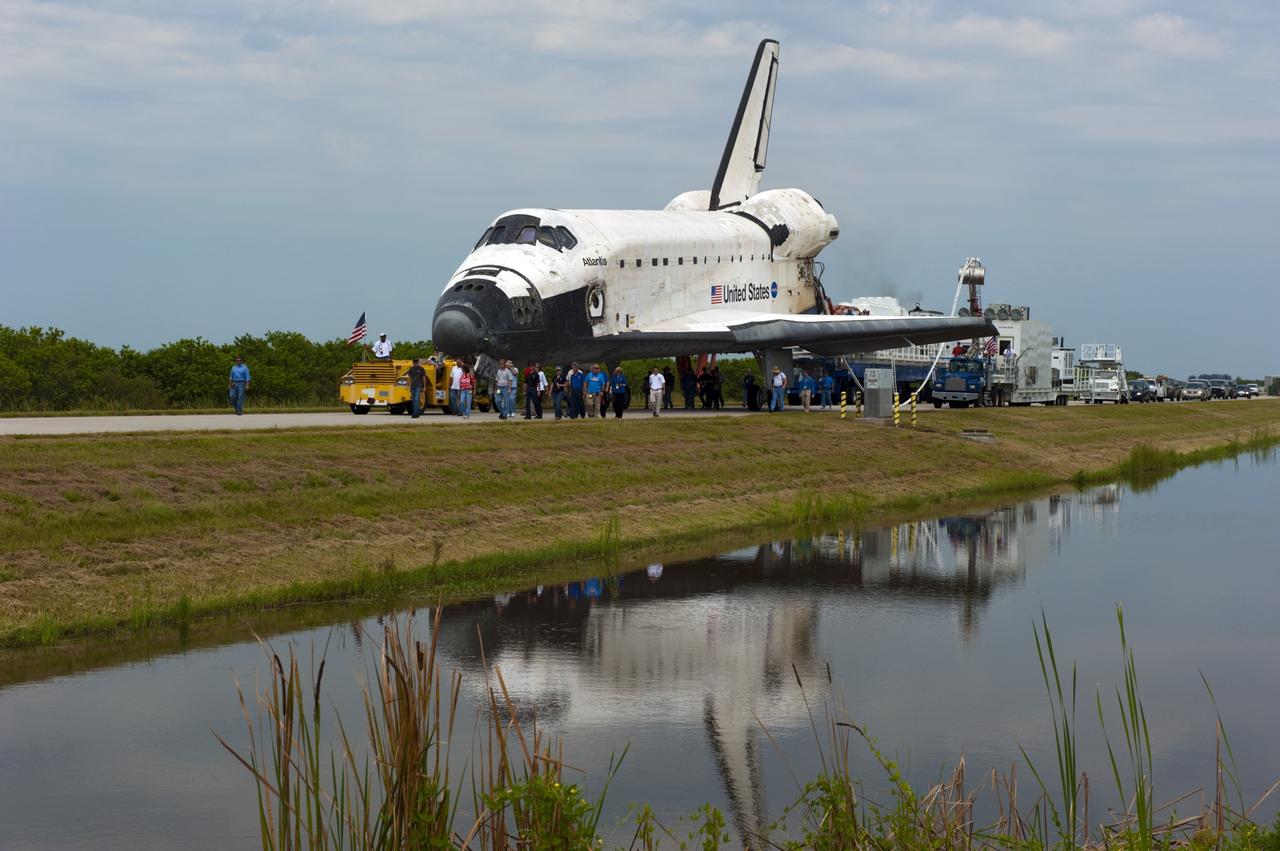 CAPE CANAVERAL, Fla. -- Media photograph space shuttle Atlantis as it is slowly towed from the Shuttle Landing Facility runway to Orbiter Processing Facility-2 for the last time. Atlantis' final return to Earth on Runway 15 at NASA's Kennedy Space Center in Florida occurred at 5:57 a.m. EDT July 21, 2011.                 Securing the space shuttle fleet's place in history, Atlantis marks the 26th nighttime landing of NASA's Space Shuttle Program and the 78th landing at Kennedy. Atlantis and its crew delivered to the International Space Station the Raffaello multi-purpose logistics module packed with more than 9,400 pounds of spare parts, equipment and supplies that will sustain station operations for the next year. STS-135 is the 33rd and final flight for Atlantis and the final mission of the Space Shuttle Program. For more information, visit www.nasa.gov/mission_pages/shuttle/shuttlemissions/sts135/index.html. Photo credit: NASA/Kim Shiflett