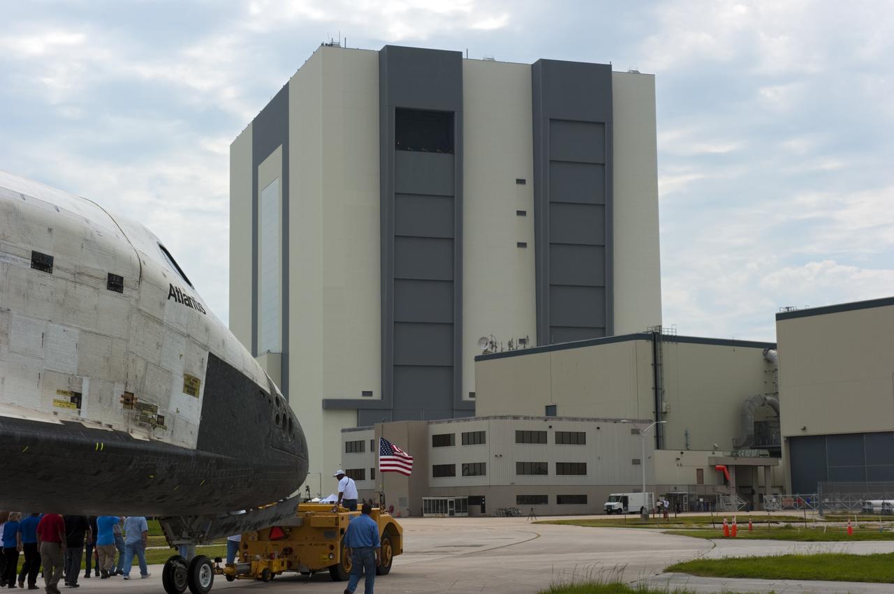CAPE CANAVERAL, Fla. -- Space shuttle Atlantis is slowly towed from the Shuttle Landing Facility runway to Orbiter Processing Facility-2 for the last time. Atlantis' final return to Earth on Runway 15 at NASA's Kennedy Space Center in Florida occurred at 5:57 a.m. EDT July 21, 2011.                  Securing the space shuttle fleet's place in history, Atlantis marks the 26th nighttime landing of NASA's Space Shuttle Program and the 78th landing at Kennedy. Atlantis and its crew delivered to the International Space Station the Raffaello multi-purpose logistics module packed with more than 9,400 pounds of spare parts, equipment and supplies that will sustain station operations for the next year. STS-135 is the 33rd and final flight for Atlantis and the final mission of the Space Shuttle Program. For more information, visit www.nasa.gov/mission_pages/shuttle/shuttlemissions/sts135/index.html. Photo credit: NASA/Kim Shiflett