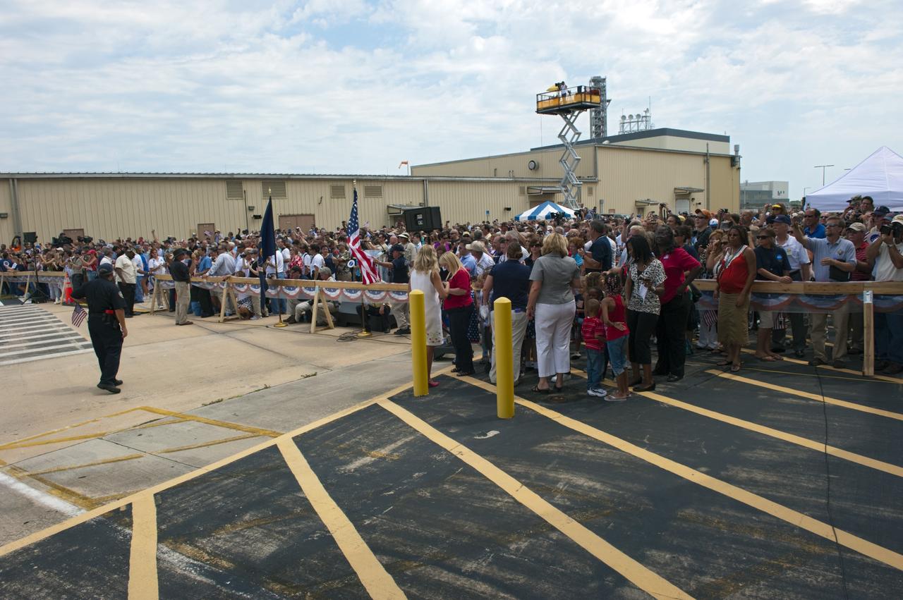 CAPE CANAVERAL, Fla. -- Thousands of workers who have processed, launched and landed space shuttles for more than three decades, gather for an employee appreciation event in front of Orbiter Processing Facility-2 at NASA's Kennedy Space Center in Florida. Atlantis' final return to Earth occurred at 5:57 a.m. EDT July 21, 2011.                     Securing the space shuttle fleet's place in history, Atlantis marks the 26th nighttime landing of NASA's Space Shuttle Program and the 78th landing at Kennedy. Atlantis and its crew delivered to the International Space Station the Raffaello multi-purpose logistics module packed with more than 9,400 pounds of spare parts, equipment and supplies that will sustain station operations for the next year. STS-135 is the 33rd and final flight for Atlantis and the final mission of the Space Shuttle Program. For more information, visit www.nasa.gov/mission_pages/shuttle/shuttlemissions/sts135/index.html. Photo credit: NASA/Kim Shiflett