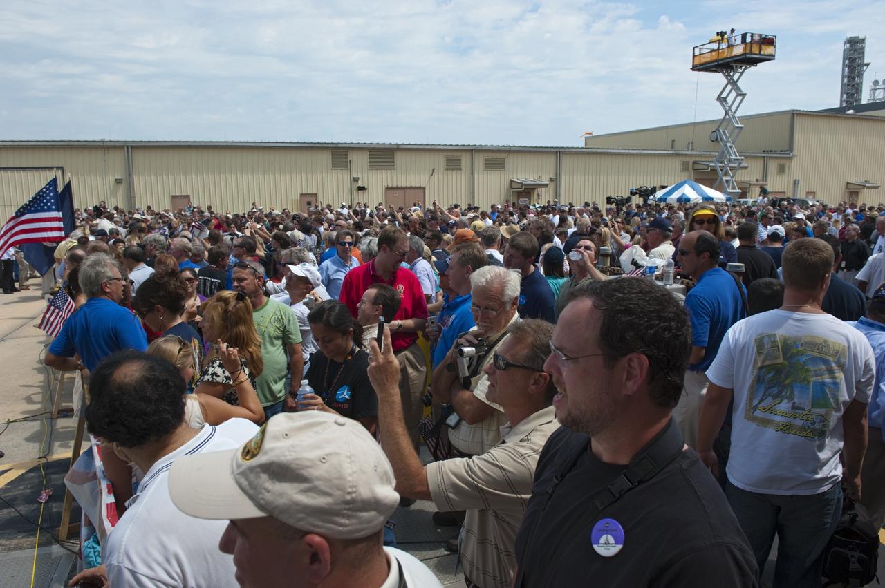 CAPE CANAVERAL, Fla. -- Thousands of workers who have processed, launched and landed space shuttles for more than three decades, gather for an employee appreciation event in front of Orbiter Processing Facility-2 at NASA's Kennedy Space Center in Florida. Atlantis' final return to Earth occurred at 5:57 a.m. EDT July 21, 2011.                     Securing the space shuttle fleet's place in history, Atlantis marks the 26th nighttime landing of NASA's Space Shuttle Program and the 78th landing at Kennedy. Atlantis and its crew delivered to the International Space Station the Raffaello multi-purpose logistics module packed with more than 9,400 pounds of spare parts, equipment and supplies that will sustain station operations for the next year. STS-135 is the 33rd and final flight for Atlantis and the final mission of the Space Shuttle Program. For more information, visit www.nasa.gov/mission_pages/shuttle/shuttlemissions/sts135/index.html. Photo credit: NASA/Kim Shiflett