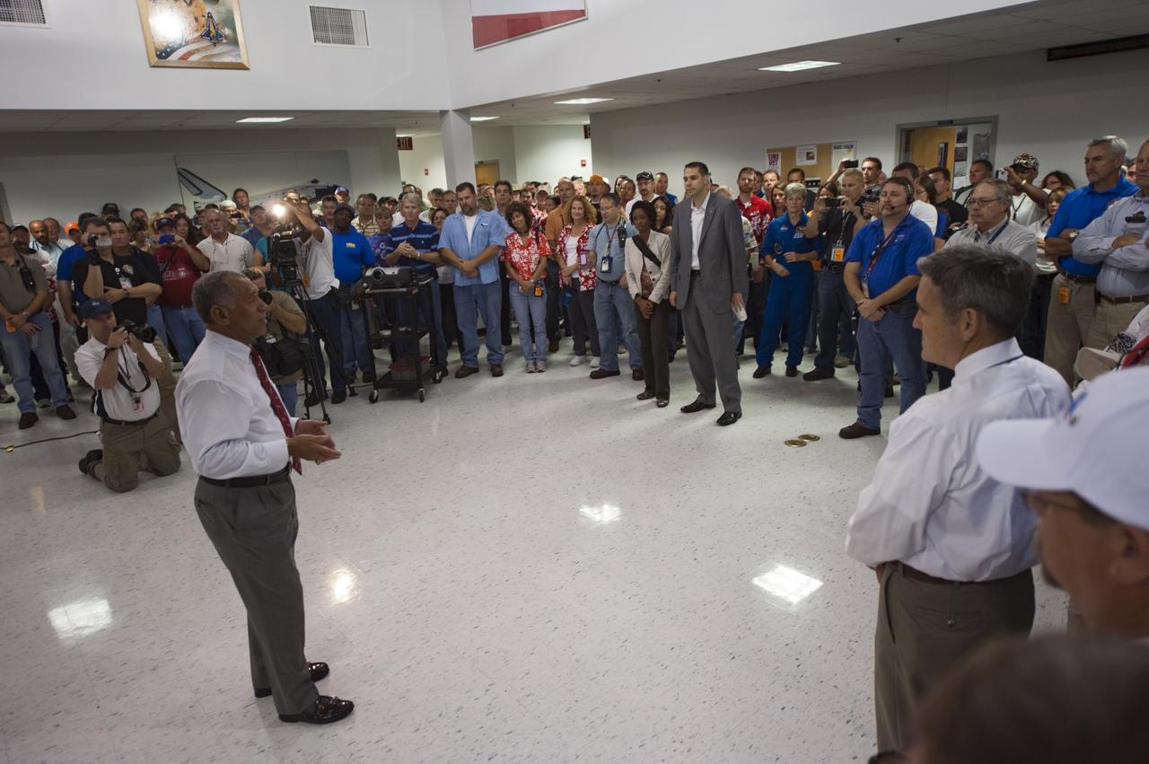 CAPE CANAVERAL, Fla. -- In the Flight Vehicle Support Building at NASA Kennedy Space Center's Shuttle Landing Facility (SLF), NASA Administrator Charles Bolden discusses strategies with NASA managers and convoy crew members during a prelanding convoy meeting. A Convoy Command Center vehicle will be positioned near shuttle Atlantis on the SLF. The command vehicle is equipped to control critical communications between the crew still aboard Atlantis and the Launch Control Center. The team will monitor the health of the orbiter systems and direct convoy operations made up of about 40 vehicles, including 25 specially designed vehicles to assist the crew in leaving the shuttle, and prepare the vehicle for towing from the SLF to its processing hangar.      Securing the space shuttle fleet's place in history, Atlantis will mark the 26th nighttime landing of NASA's Space Shuttle Program and the 78th landing at Kennedy. Atlantis and its crew delivered to the International Space Station the Raffaello multi-purpose logistics module packed with more than 9,400 pounds of spare parts, equipment and supplies that will sustain station operations for the next year. STS-135 is the 33rd and final flight for Atlantis and final mission of the Space Shuttle Program. For more information, visit www.nasa.gov/mission_pages/shuttle/shuttlemissions/sts135/index.html. Photo credit: NASA/Kim Shiflett