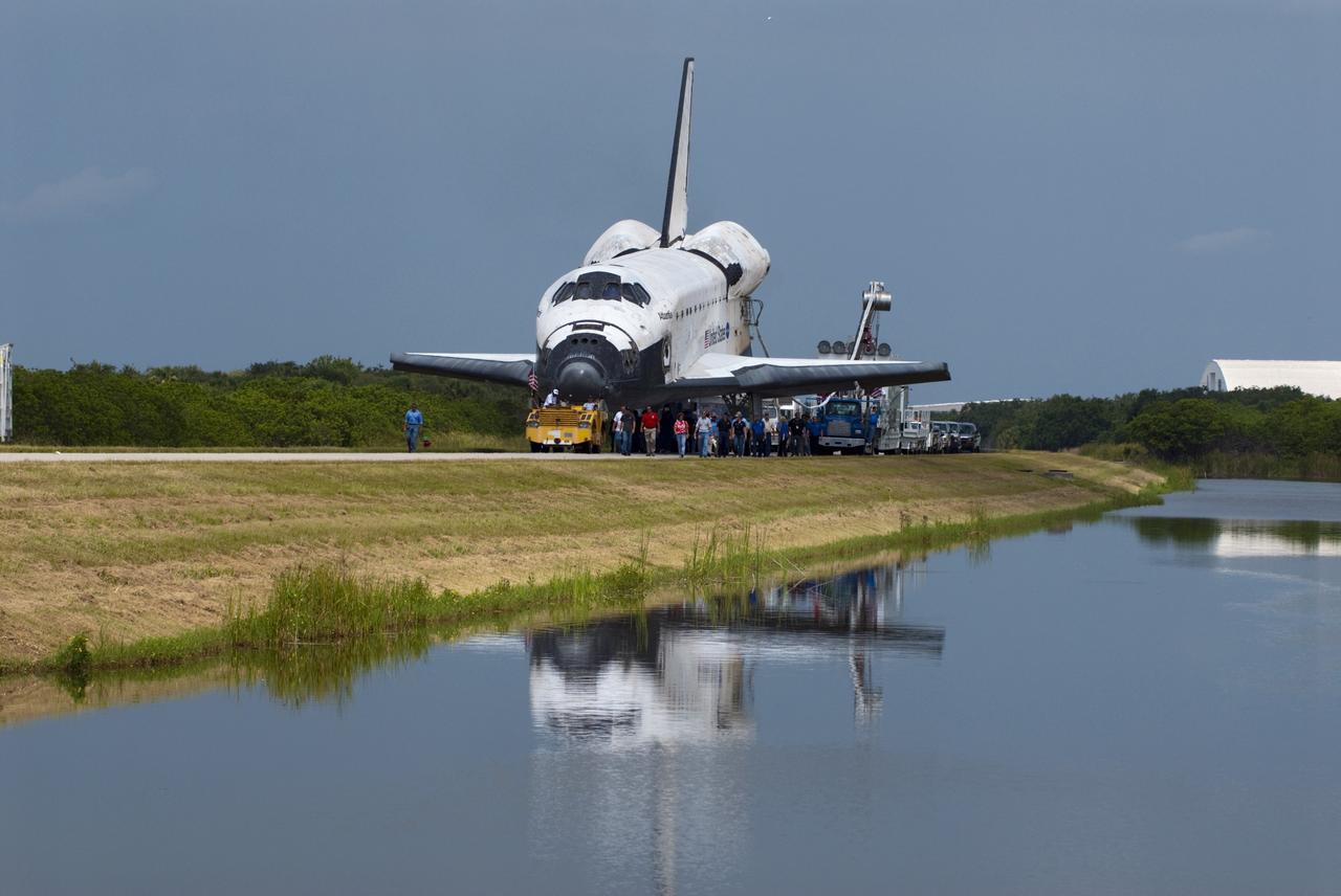 CAPE CANAVERAL, Fla. -- Space shuttle Atlantis is reflected in the water along the towway from the Shuttle Landing Facility to the Orbiter Processing Facility at NASA's Kennedy Space Center in Florida.  Atlantis' final return from space at 5:57 a.m. EDT concluded the STS-135 mission, secured the space shuttle fleet's place in history and brought a close to America's Space Shuttle Program. Main gear touchdown was at 5:57:00 a.m. EDT, followed by nose gear touchdown at 5:57:20 a.m., and wheelstop at 5:57:54 a.m. On board were STS-135 Commander Chris Ferguson, Pilot Doug Hurley, and Mission Specialists Sandra Magnus and Rex Walheim.    On the 37th shuttle mission to the International Space Station, STS-135 delivered the Raffaello multi-purpose logistics module filled with more than 9,400 pounds of spare parts, equipment and supplies that will sustain station operations for the next year. STS-135 was the 33rd and final flight for Atlantis, which has spent 307 days in space, orbited Earth 4,848 times and traveled 125,935,769 miles, and also the final mission of the Space Shuttle Program.  For more information, visit www.nasa.gov/mission_pages/shuttle/shuttlemissions/sts135/index.html. Photo credit: NASA/Kim Shiflett