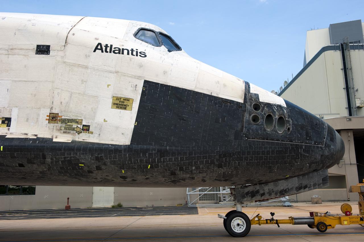 CAPE CANAVERAL, Fla. -- Space shuttle Atlantis noses its way toward the open door of Orbiter Processing Facility-2 at NASA's Kennedy Space Center in Florida. Once inside the processing facility, Atlantis will be prepared for future public display at Kennedy's Visitor Complex.    Atlantis' final return from space at 5:57 a.m. EDT concluded the STS-135 mission, secured the space shuttle fleet's place in history and brought a close to America's Space Shuttle Program. Main gear touchdown was at 5:57:00 a.m. EDT, followed by nose gear touchdown at 5:57:20 a.m., and wheelstop at 5:57:54 a.m. On board were STS-135 Commander Chris Ferguson, Pilot Doug Hurley, and Mission Specialists Sandra Magnus and Rex Walheim.  On the 37th shuttle mission to the International Space Station, STS-135 delivered the Raffaello multi-purpose logistics module filled with more than 9,400 pounds of spare parts, equipment and supplies that will sustain station operations for the next year. STS-135 was the 33rd and final flight for Atlantis, which has spent 307 days in space, orbited Earth 4,848 times and traveled 125,935,769 miles, and also the final mission of the Space Shuttle Program.  For more information, visit www.nasa.gov/mission_pages/shuttle/shuttlemissions/sts135/index.html. Photo credit: NASA/Kim Shiflett