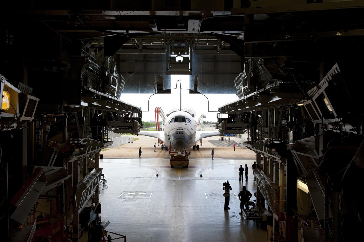 CAPE CANAVERAL, Fla. -- With the assistance of a "towback" vehicle, space shuttle Atlantis inches its way into the empty bay of Orbiter Processing Facility-2 at NASA's Kennedy Space Center in Florida. Once inside the processing facility, Atlantis will be prepared for future public display at Kennedy's Visitor Complex.    Atlantis' final return from space at 5:57 a.m. EDT concluded the STS-135 mission, secured the space shuttle fleet's place in history and brought a close to America's Space Shuttle Program. Main gear touchdown was at 5:57:00 a.m. EDT, followed by nose gear touchdown at 5:57:20 a.m., and wheelstop at 5:57:54 a.m. On board were STS-135 Commander Chris Ferguson, Pilot Doug Hurley, and Mission Specialists Sandra Magnus and Rex Walheim.  On the 37th shuttle mission to the International Space Station, STS-135 delivered the Raffaello multi-purpose logistics module filled with more than 9,400 pounds of spare parts, equipment and supplies that will sustain station operations for the next year. STS-135 was the 33rd and final flight for Atlantis, which has spent 307 days in space, orbited Earth 4,848 times and traveled 125,935,769 miles, and also the final mission of the Space Shuttle Program.  For more information, visit www.nasa.gov/mission_pages/shuttle/shuttlemissions/sts135/index.html. Photo credit: NASA/Kim Shiflett