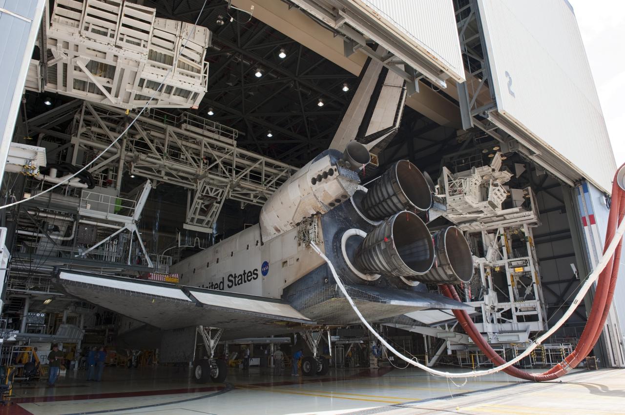CAPE CANAVERAL, Fla. -- At NASA's Kennedy Space Center in Florida, space shuttle Atlantis glides into position between the work platforms of Orbiter Processing Facility-2. A purge unit that pumps conditioned air into a shuttle after landing is connected to Atlantis' aft end.  Once inside the processing facility, Atlantis will be prepared for future public display at Kennedy's Visitor Complex.    Atlantis' final return from space at 5:57 a.m. EDT concluded the STS-135 mission, secured the space shuttle fleet's place in history and brought a close to America's Space Shuttle Program. Main gear touchdown was at 5:57:00 a.m. EDT, followed by nose gear touchdown at 5:57:20 a.m., and wheelstop at 5:57:54 a.m. On board were STS-135 Commander Chris Ferguson, Pilot Doug Hurley, and Mission Specialists Sandra Magnus and Rex Walheim.  On the 37th shuttle mission to the International Space Station, STS-135 delivered the Raffaello multi-purpose logistics module filled with more than 9,400 pounds of spare parts, equipment and supplies that will sustain station operations for the next year. STS-135 was the 33rd and final flight for Atlantis, which has spent 307 days in space, orbited Earth 4,848 times and traveled 125,935,769 miles, and also the final mission of the Space Shuttle Program.  For more information, visit www.nasa.gov/mission_pages/shuttle/shuttlemissions/sts135/index.html. Photo credit: NASA/Kim Shiflett