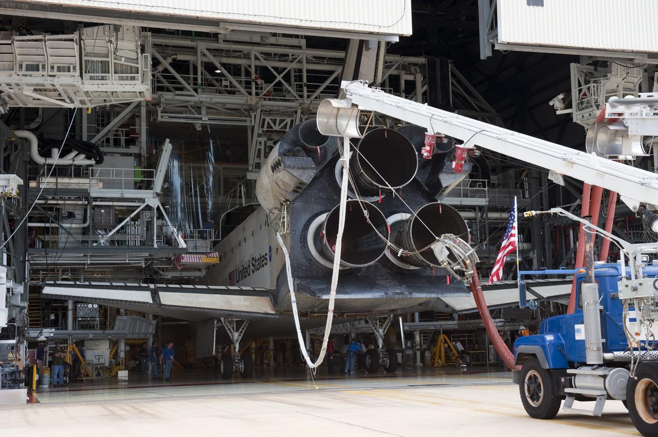 CAPE CANAVERAL, Fla. -- At NASA's Kennedy Space Center in Florida, space shuttle Atlantis is positioned between the work platforms of Orbiter Processing Facility-2 where it will be prepared for future public display at Kennedy's Visitor Complex. A purge unit that pumps conditioned air into a shuttle after landing is connected to Atlantis' aft end.    Atlantis' final return from space at 5:57 a.m. EDT concluded the STS-135 mission, secured the space shuttle fleet's place in history and brought a close to America's Space Shuttle Program. Main gear touchdown was at 5:57:00 a.m. EDT, followed by nose gear touchdown at 5:57:20 a.m., and wheelstop at 5:57:54 a.m. On board were STS-135 Commander Chris Ferguson, Pilot Doug Hurley, and Mission Specialists Sandra Magnus and Rex Walheim.  On the 37th shuttle mission to the International Space Station, STS-135 delivered the Raffaello multi-purpose logistics module filled with more than 9,400 pounds of spare parts, equipment and supplies that will sustain station operations for the next year. STS-135 was the 33rd and final flight for Atlantis, which has spent 307 days in space, orbited Earth 4,848 times and traveled 125,935,769 miles, and also the final mission of the Space Shuttle Program.  For more information, visit www.nasa.gov/mission_pages/shuttle/shuttlemissions/sts135/index.html. Photo credit: NASA/Kim Shiflett