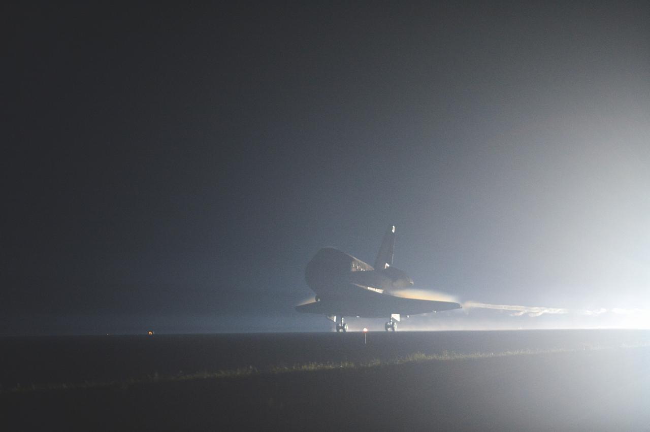 CAPE CANAVERAL, Fla. -- Space shuttle Atlantis glides out of the darkness onto the Shuttle Landing Facility's  Runway 15 at NASA's Kennedy Space Center in Florida. Atlantis marked the 26th nighttime landing of NASA's Space Shuttle Program and the 78th landing at Kennedy. Main gear touchdown was at 5:57:00 a.m. EDT, followed by nose gear touchdown at 5:57:20 a.m., and wheelstop at 5:57:54 a.m. On board are STS-135 Commander Chris Ferguson, Pilot Doug Hurley, and Mission Specialists Sandra Magnus and Rex Walheim.    On the 37th shuttle mission to the International Space Station, STS-135 delivered the Raffaello multi-purpose logistics module filled with more than 9,400 pounds of spare parts, equipment and supplies that will sustain station operations for the next year. STS-135 was the 33rd and final flight for Atlantis, which has spent 307 days in space, orbited Earth 4,848 times and traveled 125,935,769 miles, and also the final mission of the Space Shuttle Program.  For more information, visit www.nasa.gov/mission_pages/shuttle/shuttlemissions/sts135/index.html. Photo credit: NASA/Sandra Joseph and Kevin O'Connell
