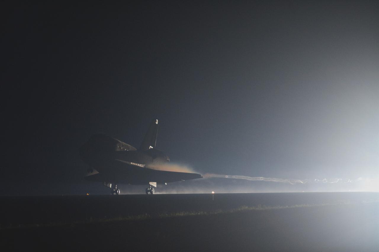 CAPE CANAVERAL, Fla. -- Space shuttle Atlantis streaks out of the darkness onto the Shuttle Landing Facility's  Runway 15 at NASA's Kennedy Space Center in Florida. Atlantis marked the 26th nighttime landing of NASA's Space Shuttle Program and the 78th landing at Kennedy. Main gear touchdown was at 5:57:00 a.m. EDT, followed by nose gear touchdown at 5:57:20 a.m., and wheelstop at 5:57:54 a.m. On board are STS-135 Commander Chris Ferguson, Pilot Doug Hurley, and Mission Specialists Sandra Magnus and Rex Walheim.    On the 37th shuttle mission to the International Space Station, STS-135 delivered the Raffaello multi-purpose logistics module filled with more than 9,400 pounds of spare parts, equipment and supplies that will sustain station operations for the next year. STS-135 was the 33rd and final flight for Atlantis, which has spent 307 days in space, orbited Earth 4,848 times and traveled 125,935,769 miles, and also the final mission of the Space Shuttle Program.  For more information, visit www.nasa.gov/mission_pages/shuttle/shuttlemissions/sts135/index.html. Photo credit: NASA/Sandra Joseph and Kevin O'Connell