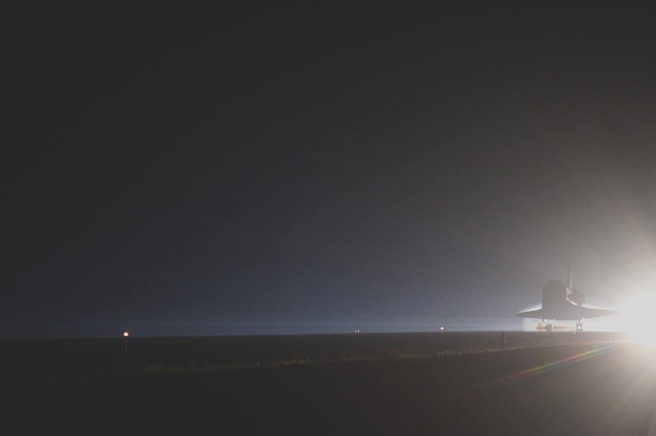 CAPE CANAVERAL, Fla. -- Backlit by the xenon lights on Runway 15 at the Shuttle Landing Facility, space shuttle Atlantis nears touchdown for the final time at NASA's Kennedy Space Center in Florida.  Securing the space shuttle fleet's place in history, Atlantis marked the 26th nighttime landing of NASA's Space Shuttle Program and the 78th landing at Kennedy. Main gear touchdown was at 5:57:00 a.m. EDT, followed by nose gear touchdown at 5:57:20 a.m., and wheelstop at 5:57:54 a.m. On board are STS-135 Commander Chris Ferguson, Pilot Doug Hurley, and Mission Specialists Sandra Magnus and Rex Walheim.    On the 37th shuttle mission to the International Space Station, STS-135 delivered the Raffaello multi-purpose logistics module filled with more than 9,400 pounds of spare parts, equipment and supplies that will sustain station operations for the next year. STS-135 was the 33rd and final flight for Atlantis, which has spent 307 days in space, orbited Earth 4,848 times and traveled 125,935,769 miles. It was the final mission of the Space Shuttle Program.  For more information, visit www.nasa.gov/mission_pages/shuttle/shuttlemissions/sts135/index.html. Photo credit: NASA/Sandra Joseph and Kevin O'Connell