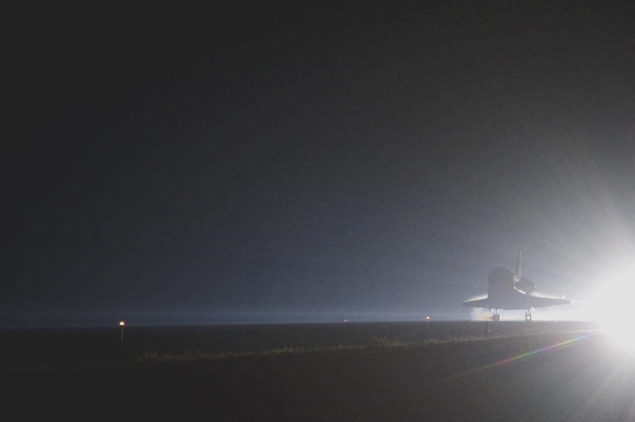 CAPE CANAVERAL, Fla. -- Space shuttle Atlantis moves out of the spotlight and into the history books as it lands on Runway 15 at the Shuttle Landing Facility at NASA's Kennedy Space Center in Florida. Atlantis marked the 26th nighttime landing of NASA's Space Shuttle Program and the 78th landing at Kennedy. Main gear touchdown was at 5:57:00 a.m. EDT, followed by nose gear touchdown at 5:57:20 a.m., and wheelstop at 5:57:54 a.m. On board are STS-135 Commander Chris Ferguson, Pilot Doug Hurley, and Mission Specialists Sandra Magnus and Rex Walheim.    On the 37th shuttle mission to the International Space Station, STS-135 delivered the Raffaello multi-purpose logistics module filled with more than 9,400 pounds of spare parts, equipment and supplies that will sustain station operations for the next year. STS-135 was the 33rd and final flight for Atlantis, which has spent 307 days in space, orbited Earth 4,848 times and traveled 125,935,769 miles. It was the final mission of the Space Shuttle Program.  For more information, visit www.nasa.gov/mission_pages/shuttle/shuttlemissions/sts135/index.html. Photo credit: NASA/Sandra Joseph and Kevin O'Connell