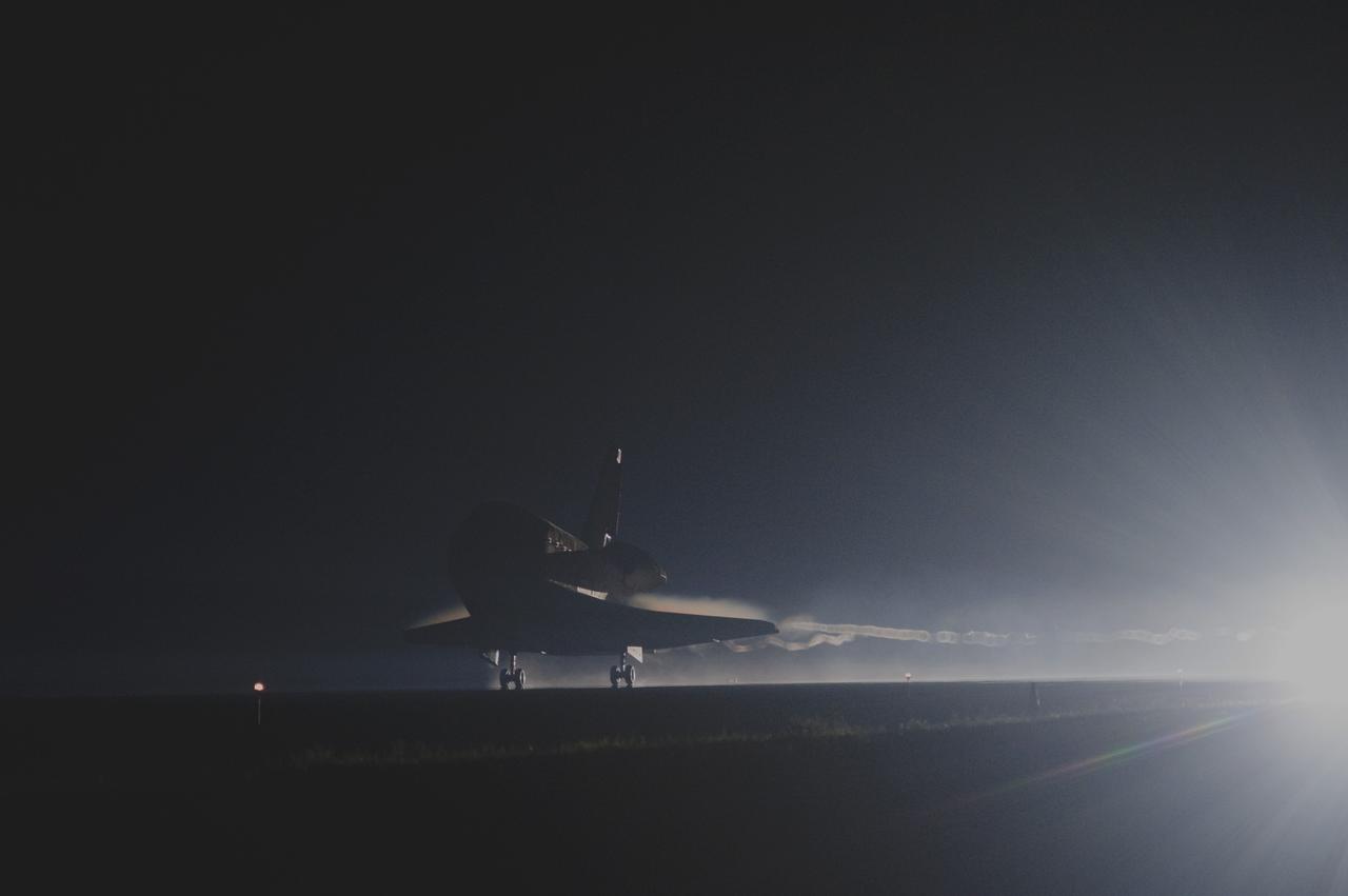 CAPE CANAVERAL, Fla. -- Trailing ribbons of steam and smoke, space shuttle Atlantis touches down for the final time on the Shuttle Landing Facility's Runway 15 at NASA's Kennedy Space Center in Florida. Securing the space shuttle fleet's place in history, Atlantis marked the 26th nighttime landing of NASA's Space Shuttle Program and the 78th landing at Kennedy. Main gear touchdown was at 5:57:00 a.m. EDT, followed by nose gear touchdown at 5:57:20 a.m., and wheelstop at 5:57:54 a.m. On board are STS-135 Commander Chris Ferguson, Pilot Doug Hurley, and Mission Specialists Sandra Magnus and Rex Walheim.    On the 37th shuttle mission to the International Space Station, STS-135 delivered the Raffaello multi-purpose logistics module filled with more than 9,400 pounds of spare parts, equipment and supplies that will sustain station operations for the next year. STS-135 was the 33rd and final flight for Atlantis, which has spent 307 days in space, orbited Earth 4,848 times and traveled 125,935,769 miles. It was the final mission of the Space Shuttle Program.  For more information, visit www.nasa.gov/mission_pages/shuttle/shuttlemissions/sts135/index.html. Photo credit: NASA/Sandra Joseph and Kevin O'Connell