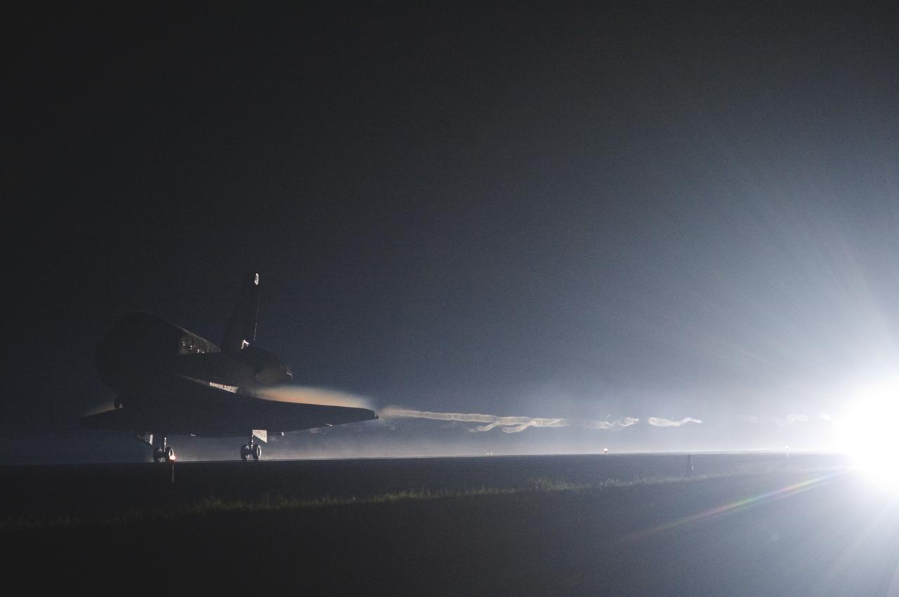 CAPE CANAVERAL, Fla. -- Space shuttle Atlantis streaks out of the darkness onto the Shuttle Landing Facility's  Runway 15 at NASA's Kennedy Space Center in Florida. Atlantis marked the 26th nighttime landing of NASA's Space Shuttle Program and the 78th landing at Kennedy. Main gear touchdown was at 5:57:00 a.m. EDT, followed by nose gear touchdown at 5:57:20 a.m., and wheelstop at 5:57:54 a.m. On board are STS-135 Commander Chris Ferguson, Pilot Doug Hurley, and Mission Specialists Sandra Magnus and Rex Walheim.    On the 37th shuttle mission to the International Space Station, STS-135 delivered the Raffaello multi-purpose logistics module filled with more than 9,400 pounds of spare parts, equipment and supplies that will sustain station operations for the next year. STS-135 was the 33rd and final flight for Atlantis, which has spent 307 days in space, orbited Earth 4,848 times and traveled 125,935,769 miles. It was the final mission of the Space Shuttle Program.  For more information, visit www.nasa.gov/mission_pages/shuttle/shuttlemissions/sts135/index.html. Photo credit: NASA/Sandra Joseph and Kevin O'Connell