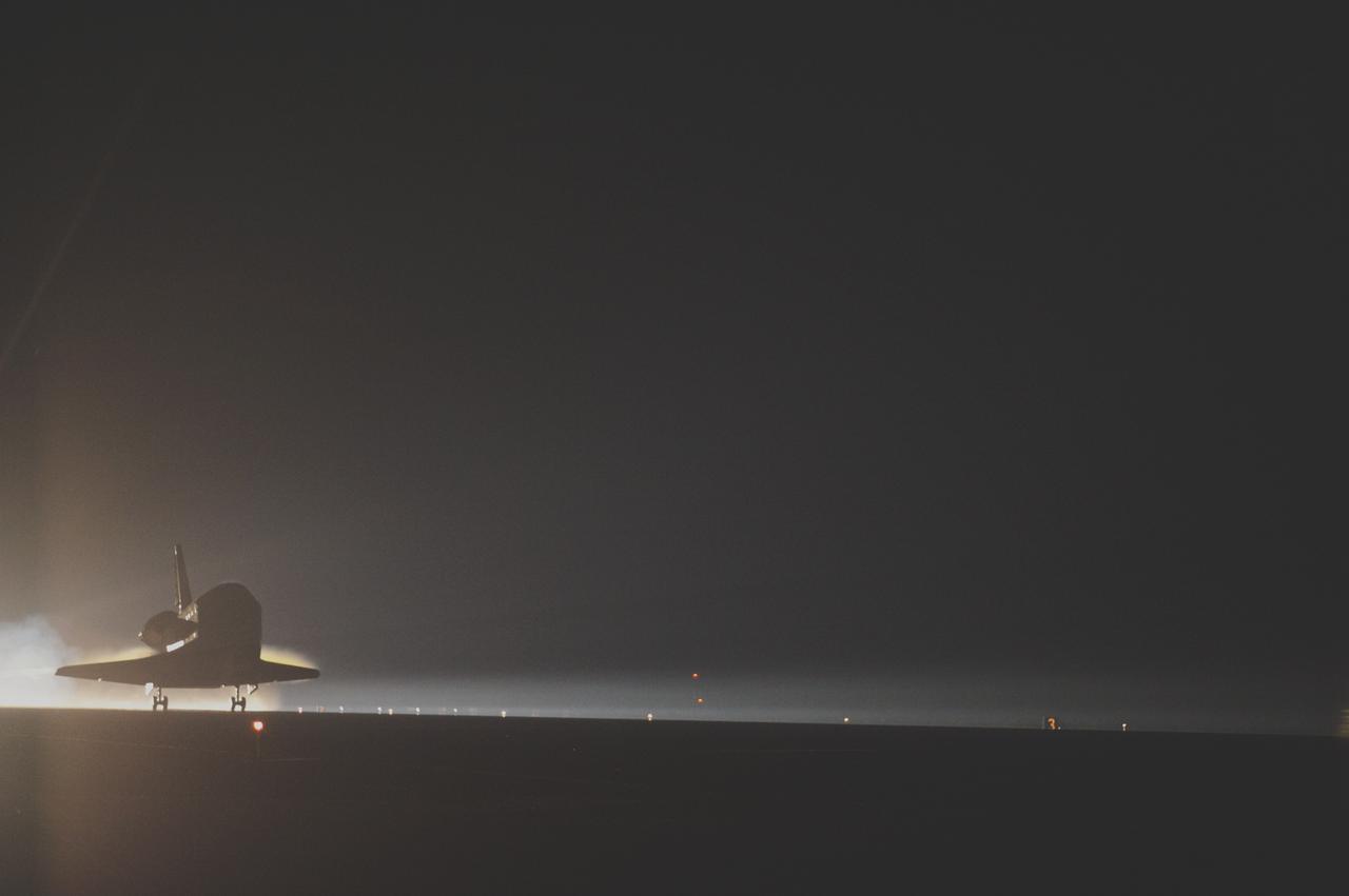 CAPE CANAVERAL, Fla. -- Space shuttle Atlantis glides out of the darkness onto the Shuttle Landing Facility's  Runway 15 at NASA's Kennedy Space Center in Florida. Atlantis marked the 26th nighttime landing of NASA's Space Shuttle Program and the 78th landing at Kennedy. Main gear touchdown was at 5:57:00 a.m. EDT, followed by nose gear touchdown at 5:57:20 a.m., and wheelstop at 5:57:54 a.m. On board are STS-135 Commander Chris Ferguson, Pilot Doug Hurley, and Mission Specialists Sandra Magnus and Rex Walheim.    On the 37th shuttle mission to the International Space Station, STS-135 delivered the Raffaello multi-purpose logistics module filled with more than 9,400 pounds of spare parts, equipment and supplies that will sustain station operations for the next year. STS-135 was the 33rd and final flight for Atlantis, which has spent 307 days in space, orbited Earth 4,848 times and traveled 125,935,769 miles. It was the final mission of the Space Shuttle Program.  For more information, visit www.nasa.gov/mission_pages/shuttle/shuttlemissions/sts135/index.html. Photo credit: NASA/Sandra Joseph and Kevin O'Connell