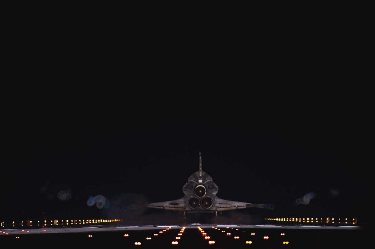 CAPE CANAVERAL, Fla. -- Vapor trails follow space shuttle Atlantis as it touches down on Runway 15 on the Shuttle Landing Facility at NASA's Kennedy Space Center in Florida for the final time. A vapor trail, known as a contrail, is a cloud of water vapor that condenses and freezes around the small particles in aircraft exhaust. Atlantis marked the 26th nighttime landing of NASA's Space Shuttle Program and the 78th landing at Kennedy. It also was the final mission for the shuttle program.    STS-135 was the 33rd and final flight for Atlantis, which has spent 307 days in space, orbited Earth 4,848 times and traveled 125,935,769 miles. For more information on the space shuttle era, visit www.nasa.gov/mission_pages/shuttle/flyout. Photo credit: NASA/Sandra Joseph and Kevin O'Connell