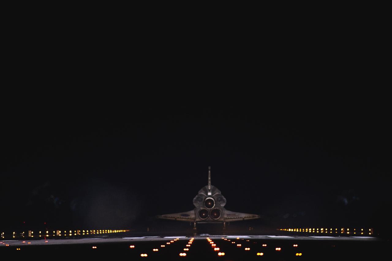 CAPE CANAVERAL, Fla. -- Space shuttle Atlantis begins to disappear into the darkness as it rolls to a stop on Runway 15 on the Shuttle Landing Facility at NASA's Kennedy Space Center in Florida for the final time. Atlantis marked the 26th nighttime landing of NASA's Space Shuttle Program and the 78th landing at Kennedy. It also was the final mission for the shuttle program.      STS-135 was the 33rd and final flight for Atlantis, which has spent 307 days in space, orbited Earth 4,848 times and traveled 125,935,769 miles. For more information on the space shuttle era, visit www.nasa.gov/mission_pages/shuttle/flyout. Photo credit: NASA/Sandra Joseph and Kevin O'Connell