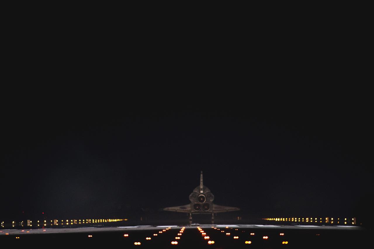 CAPE CANAVERAL, Fla. -- Space shuttle Atlantis begins to disappear into the darkness as it rolls to a stop on Runway 15 on the Shuttle Landing Facility at NASA's Kennedy Space Center in Florida for the final time. Atlantis marked the 26th nighttime landing of NASA's Space Shuttle Program and the 78th landing at Kennedy. It also was the final mission for the shuttle program.    STS-135 was the 33rd and final flight for Atlantis, which has spent 307 days in space, orbited Earth 4,848 times and traveled 125,935,769 miles. For more information on the space shuttle era, visit www.nasa.gov/mission_pages/shuttle/flyout. Photo credit: NASA/Sandra Joseph and Kevin O'Connell