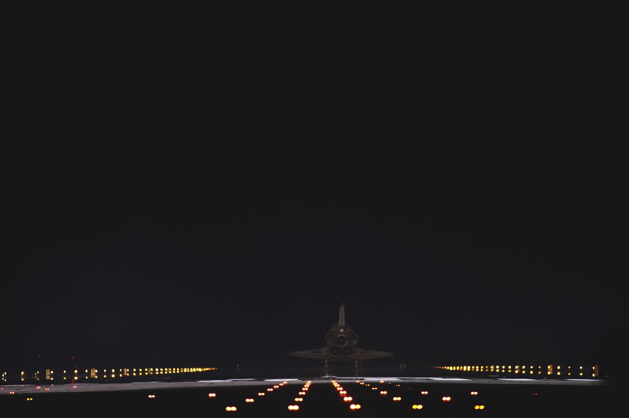 CAPE CANAVERAL, Fla. -- Space shuttle Atlantis disappears into the darkness as it rolls to a stop on Runway 15 on the Shuttle Landing Facility at NASA's Kennedy Space Center in Florida for the final time. Atlantis marked the 26th nighttime landing of NASA's Space Shuttle Program and the 78th landing at Kennedy. It also was the final mission for the shuttle program.      STS-135 was the 33rd and final flight for Atlantis, which has spent 307 days in space, orbited Earth 4,848 times and traveled 125,935,769 miles. For more information on the space shuttle era, visit www.nasa.gov/mission_pages/shuttle/flyout. Photo credit: NASA/Sandra Joseph and Kevin O'Connell