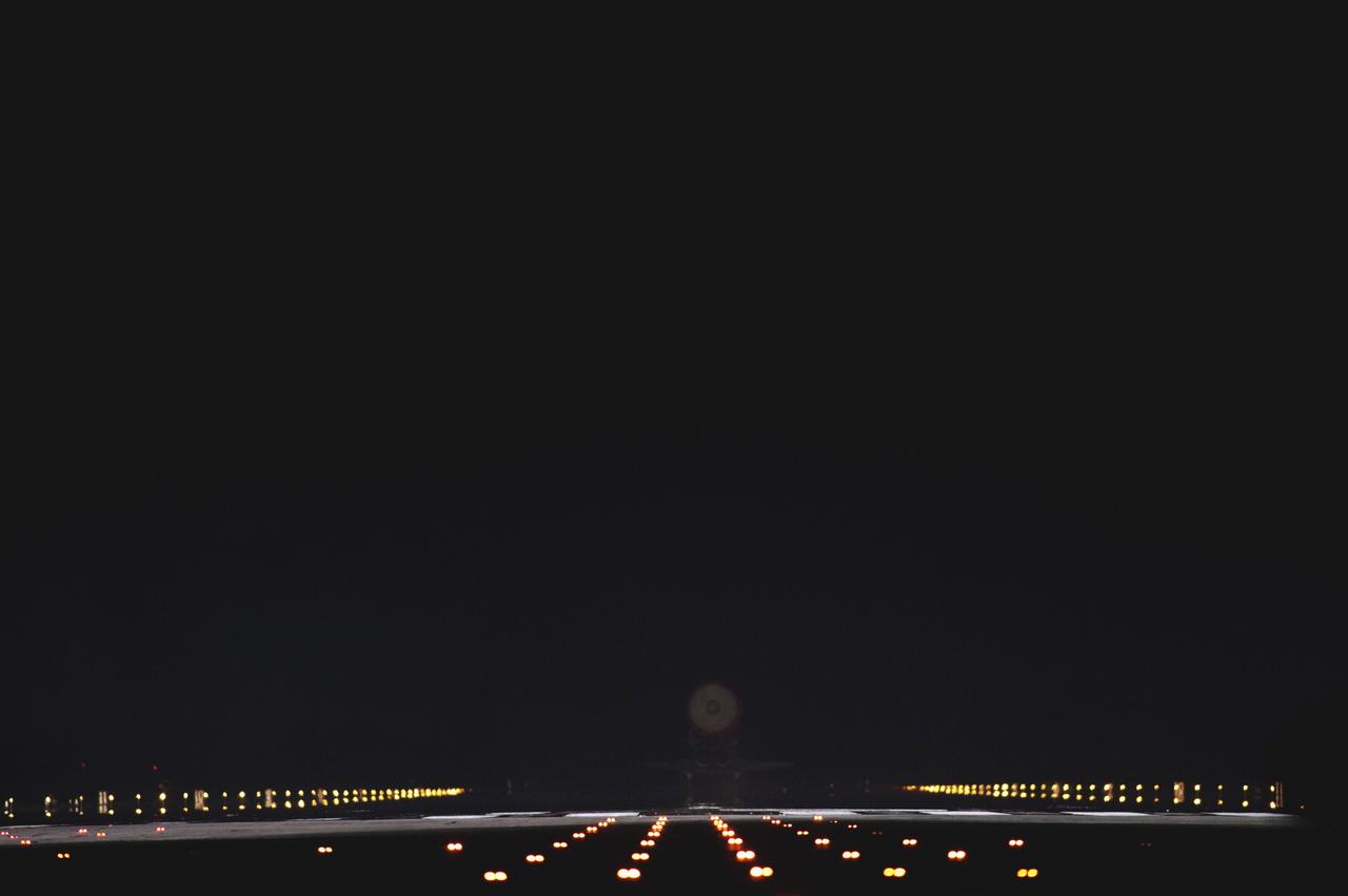 CAPE CANAVERAL, Fla. -- Only space shuttle Atlantis' drag chute is visible as the spacecraft disappears into the darkness and rolls to a stop on Runway 15 on the Shuttle Landing Facility at NASA's Kennedy Space Center in Florida for the final time. Atlantis marked the 26th nighttime landing of NASA's Space Shuttle Program and the 78th landing at Kennedy. It also was the final mission for the shuttle program.    STS-135 was the 33rd and final flight for Atlantis, which has spent 307 days in space, orbited Earth 4,848 times and traveled 125,935,769 miles. For more information on the space shuttle era, visit www.nasa.gov/mission_pages/shuttle/flyout. Photo credit: NASA/Sandra Joseph and Kevin O'Connell