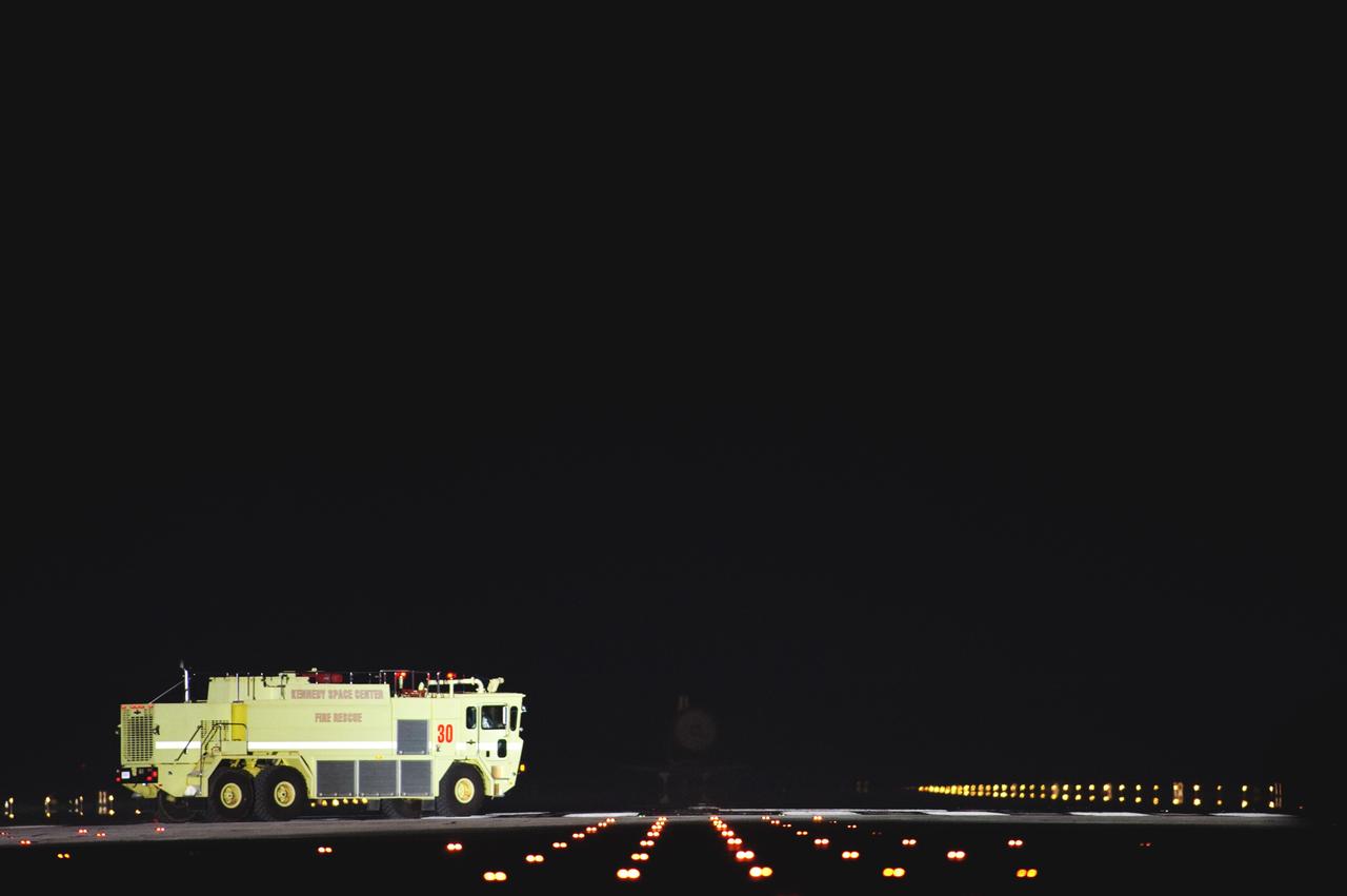 CAPE CANAVERAL, Fla. -- A NASA Fire Rescue truck, which is part of the landing convoy at NASA's Kennedy Space Center in Florida, heads out toward space shuttle Atlantis after it rolled to a stop on the Shuttle Landing Facility's Runway for the final time. Atlantis marked the 26th nighttime landing of NASA's Space Shuttle Program and the 78th landing at Kennedy. It also was the final mission for the shuttle program.    STS-135 was the 33rd and final flight for Atlantis, which has spent 307 days in space, orbited Earth 4,848 times and traveled 125,935,769 miles. For more information on the space shuttle era, visit www.nasa.gov/mission_pages/shuttle/flyout. Photo credit: NASA/Sandra Joseph and Kevin O'Connell