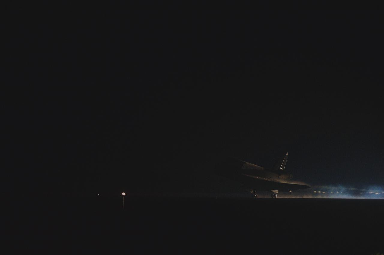 CAPE CANAVERAL, Fla. -- Space shuttle Atlantis seems almost a mirage as it lands on Runway 15 at the Shuttle Landing Facility at NASA's Kennedy Space Center in Florida. Securing the space shuttle fleet's place in history, Atlantis marked the 26th nighttime landing of NASA's Space Shuttle Program and the 78th landing at Kennedy. Main gear touchdown was at 5:57:00 a.m. EDT, followed by nose gear touchdown at 5:57:20 a.m., and wheelstop at 5:57:54 a.m. On board are STS-135 Commander Chris Ferguson, Pilot Doug Hurley, and Mission Specialists Sandra Magnus and Rex Walheim.    On the 37th shuttle mission to the International Space Station, STS-135 delivered the Raffaello multi-purpose logistics module filled with more than 9,400 pounds of spare parts, equipment and supplies that will sustain station operations for the next year. STS-135 was the 33rd and final flight for Atlantis, which has spent 307 days in space, orbited Earth 4,848 times and traveled 125,935,769 miles.  It was the final mission of the Space Shuttle Program.  For more information, visit www.nasa.gov/mission_pages/shuttle/shuttlemissions/sts135/index.html. Photo credit: NASA/Sandra Joseph and Kevin O'Connell
