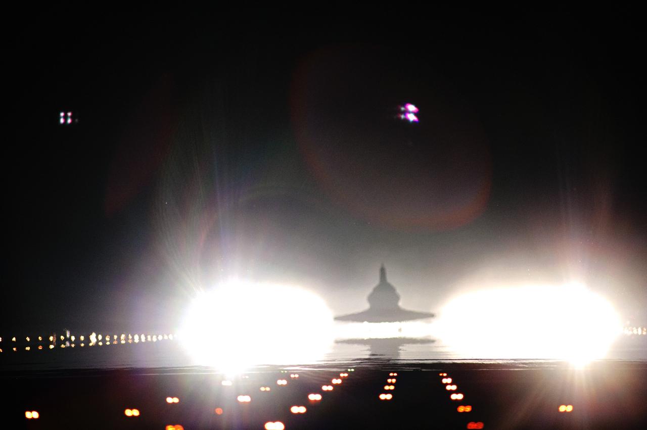 CAPE CANAVERAL, Fla. -- Xenon lights positioned at the end of Runway 15 spotlight space shuttle Atlantis as it nears touchdown for the last time at NASA's Kennedy Space Center in Florida. Securing the space shuttle fleet's place in history, Atlantis marked the 26th nighttime landing of NASA's Space Shuttle Program and the 78th landing at Kennedy. Main gear touchdown was at 5:57:00 a.m. EDT, followed by nose gear touchdown at 5:57:20 a.m., and wheelstop at 5:57:54 a.m. On board are STS-135 Commander Chris Ferguson, Pilot Doug Hurley, and Mission Specialists Sandy Magnus and Rex Walheim.    On the 37th shuttle mission to the International Space Station, STS-135 delivered the Raffaello multi-purpose logistics module filled with more than 9,400 pounds of spare parts, equipment and supplies that will sustain station operations for the next year. STS-135 was the 33rd and final flight for Atlantis, which has spent 307 days in space, orbited Earth 4,848 times and traveled 125,935,769 miles. STS-135 also was the final mission of the Space Shuttle Program.  For more information, visit www.nasa.gov/mission_pages/shuttle/shuttlemissions/sts135/index.html. Photo credit: NASA/Tom Farrar and Tony Gray