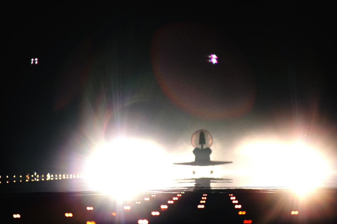 CAPE CANAVERAL, Fla. -- Xenon lights positioned at the end of Runway 15 spotlight space shuttle Atlantis as it nears touchdown for the last time at NASA's Kennedy Space Center in Florida. Securing the space shuttle fleet's place in history, Atlantis marked the 26th nighttime landing of NASA's Space Shuttle Program and the 78th landing at Kennedy. Main gear touchdown was at 5:57:00 a.m. EDT, followed by nose gear touchdown at 5:57:20 a.m., and wheelstop at 5:57:54 a.m. On board are STS-135 Commander Chris Ferguson, Pilot Doug Hurley, and Mission Specialists Sandy Magnus and Rex Walheim.    On the 37th shuttle mission to the International Space Station, STS-135 delivered the Raffaello multi-purpose logistics module filled with more than 9,400 pounds of spare parts, equipment and supplies that will sustain station operations for the next year. STS-135 was the 33rd and final flight for Atlantis, which has spent 307 days in space, orbited Earth 4,848 times and traveled 125,935,769 miles. STS-135 also was the final mission of the Space Shuttle Program.  For more information, visit www.nasa.gov/mission_pages/shuttle/shuttlemissions/sts135/index.html. Photo credit: NASA/Tom Farrar and Tony Gray