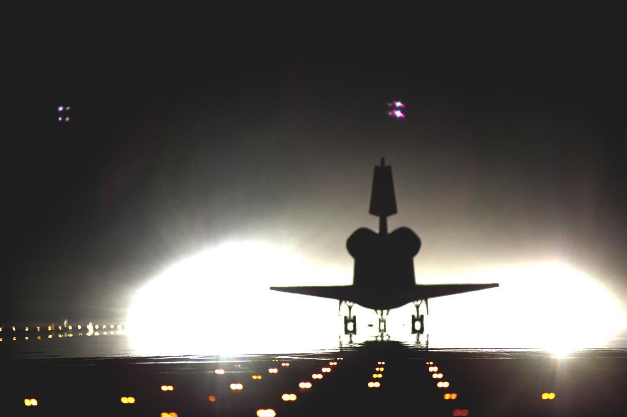 CAPE CANAVERAL, Fla. -- At NASA's Kennedy Space Center in Florida, xenon lights positioned at the end of Runway 15 illuminate the Shuttle Landing Facility for space shuttle Atlantis' final return from space. Securing the space shuttle fleet's place in history, Atlantis marked the 26th nighttime landing of NASA's Space Shuttle Program and the 78th landing at Kennedy. Main gear touchdown was at 5:57:00 a.m. EDT, followed by nose gear touchdown at 5:57:20 a.m., and wheelstop at 5:57:54 a.m. On board are STS-135 Commander Chris Ferguson, Pilot Doug Hurley, and Mission Specialists Sandy Magnus and Rex Walheim.    On the 37th shuttle mission to the International Space Station, STS-135 delivered the Raffaello multi-purpose logistics module filled with more than 9,400 pounds of spare parts, equipment and supplies that will sustain station operations for the next year. STS-135 was the 33rd and final flight for Atlantis, which has spent 307 days in space, orbited Earth 4,848 times and traveled 125,935,769 miles. STS-135 also was the final mission of the Space Shuttle Program.  For more information, visit www.nasa.gov/mission_pages/shuttle/shuttlemissions/sts135/index.html. Photo credit: NASA/Tom Farrar and Tony Gray