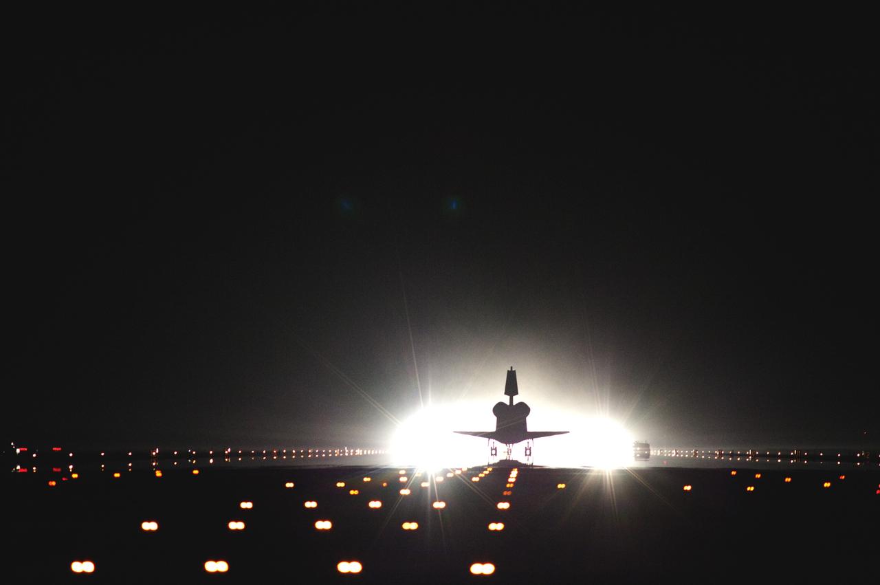 CAPE CANAVERAL, Fla. -- Space shuttle Atlantis rolls out of its xenon spotlights and into the history books as it lands on Runway 15 at the Shuttle Landing Facility at NASA's Kennedy Space Center in Florida. Atlantis marked the 26th nighttime landing of NASA's Space Shuttle Program and the 78th landing at Kennedy. Main gear touchdown was at 5:57:00 a.m. EDT, followed by nose gear touchdown at 5:57:20 a.m., and wheelstop at 5:57:54 a.m. On board are STS-135 Commander Chris Ferguson, Pilot Doug Hurley, and Mission Specialists Sandy Magnus and Rex Walheim.    On the 37th shuttle mission to the International Space Station, STS-135 delivered the Raffaello multi-purpose logistics module filled with more than 9,400 pounds of spare parts, equipment and supplies that will sustain station operations for the next year. STS-135 was the 33rd and final flight for Atlantis, which has spent 307 days in space, orbited Earth 4,848 times and traveled 125,935,769 miles. STS-135 also was the final mission of the Space Shuttle Program.  For more information, visit www.nasa.gov/mission_pages/shuttle/shuttlemissions/sts135/index.html. Photo credit: NASA/Tom Farrar and Tony Gray