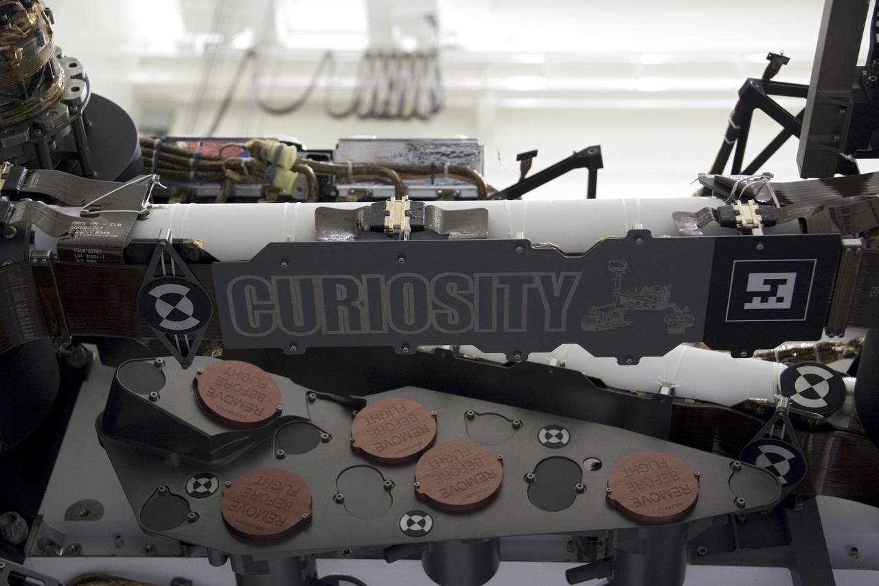 Cape Canaveral, Fla. -- At the Payload Hazardous Servicing Facility at NASA's Kennedy Space Center, the name of NASA's Mars Science Laboratory (MSL) rover, Curiosity, is emblazoned on its framework. A United Launch Alliance Atlas V-541 configuration will be used to loft MSL into space. Curiosity’s 10 science instruments are designed to search for evidence on whether Mars has had environments favorable to microbial life, including chemical ingredients for life. The unique rover will use a laser to look inside rocks and release its gasses so that the rover’s spectrometer can analyze and send the data back to Earth. MSL is scheduled to launch from Cape Canaveral Air Force Station in Florida Nov. 25 with a window extending to Dec. 18 and arrival at Mars Aug. 2012. For more information, visit http://www.nasa.gov/msl. Photo credit: NASA/Jim Grossmann