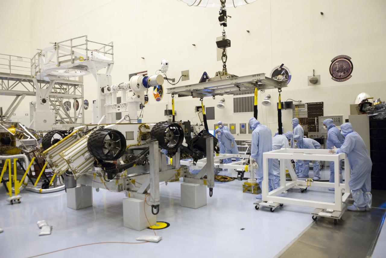 CAPE CANAVERAL, Fla. -- Technicians in the Payload Hazardous Servicing Facility at NASA's Kennedy Space Center in Florida prepare an overhead crane to move NASA's Mars Science Laboratory (MSL) rover, known as Curiosity, to a rotation fixture for testing. A United Launch Alliance Atlas V-541 configuration will be used to loft MSL into space. Curiosity’s 10 science instruments are designed to search for evidence on whether Mars has had environments favorable to microbial life, including chemical ingredients for life. The unique rover will use a laser to look inside rocks and release its gasses so that the rover’s spectrometer can analyze and send the data back to Earth. MSL is scheduled to launch from Cape Canaveral Air Force Station in Florida Nov. 25 with a window extending to Dec. 18 and arrival at Mars Aug. 2012. For more information, visit http://www.nasa.gov/msl. Photo credit: NASA/Jim Grossmann
