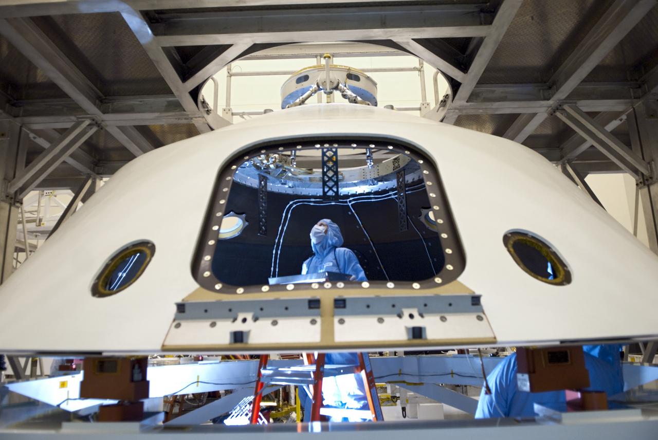 CAPE CANAVERAL, Fla. -- In the Payload Hazardous Servicing Facility at NASA's Kennedy Space Center in Florida, technicians process the backshell for NASA's Mars Science Laboratory (MSL). The spacecraft's backshell carries the parachute and several components used during later stages of entry, descent and landing of MSL's rover, Curiosity. A United Launch Alliance Atlas V-541 configuration will be used to loft MSL into space. Curiosity’s 10 science instruments are designed to search for evidence on whether Mars has had environments favorable to microbial life, including chemical ingredients for life. The unique rover will use a laser to look inside rocks and release its gasses so that the rover’s spectrometer can analyze and send the data back to Earth. MSL is scheduled to launch from Cape Canaveral Air Force Station in Florida Nov. 25 with a window extending to Dec. 18 and arrival at Mars Aug. 2012. For more information, visit http://www.nasa.gov/msl. Photo credit: NASA/Jim Grossmann