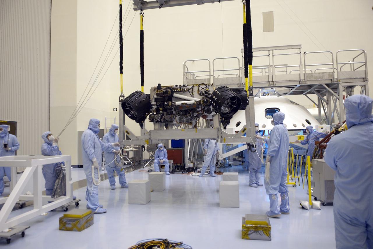 CAPE CANAVERAL, Fla. -- Technicians, using an overhead crane in the Payload Hazardous Servicing Facility at NASA's Kennedy Space Center in Florida, lift NASA's Mars Science Laboratory (MSL) rover, known as Curiosity, for its move to a rotation fixture for testing. A United Launch Alliance Atlas V-541 configuration will be used to loft MSL into space. Curiosity’s 10 science instruments are designed to search for evidence on whether Mars has had environments favorable to microbial life, including chemical ingredients for life. The unique rover will use a laser to look inside rocks and release its gasses so that the rover’s spectrometer can analyze and send the data back to Earth. MSL is scheduled to launch from Cape Canaveral Air Force Station in Florida Nov. 25 with a window extending to Dec. 18 and arrival at Mars Aug. 2012. For more information, visit http://www.nasa.gov/msl. Photo credit: NASA/Jim Grossmann