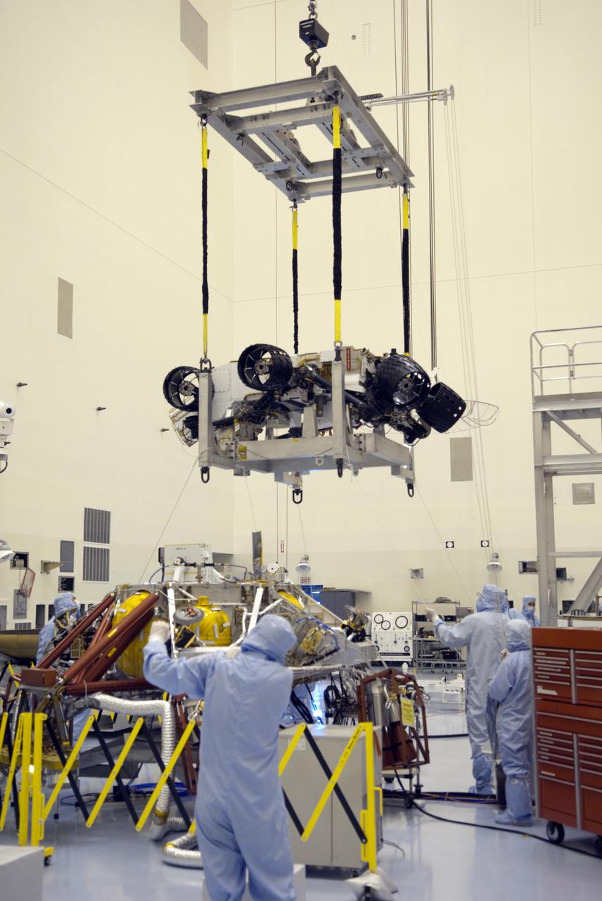 CAPE CANAVERAL, Fla. -- Technicians, using an overhead crane in the Payload Hazardous Servicing Facility at NASA's Kennedy Space Center in Florida, lift NASA's Mars Science Laboratory (MSL) rover, known as Curiosity, for its move to a rotation fixture for testing. A United Launch Alliance Atlas V-541 configuration will be used to loft MSL into space. Curiosity’s 10 science instruments are designed to search for evidence on whether Mars has had environments favorable to microbial life, including chemical ingredients for life. The unique rover will use a laser to look inside rocks and release its gasses so that the rover’s spectrometer can analyze and send the data back to Earth. MSL is scheduled to launch from Cape Canaveral Air Force Station in Florida Nov. 25 with a window extending to Dec. 18 and arrival at Mars Aug. 2012. For more information, visit http://www.nasa.gov/msl. Photo credit: NASA/Jim Grossmann