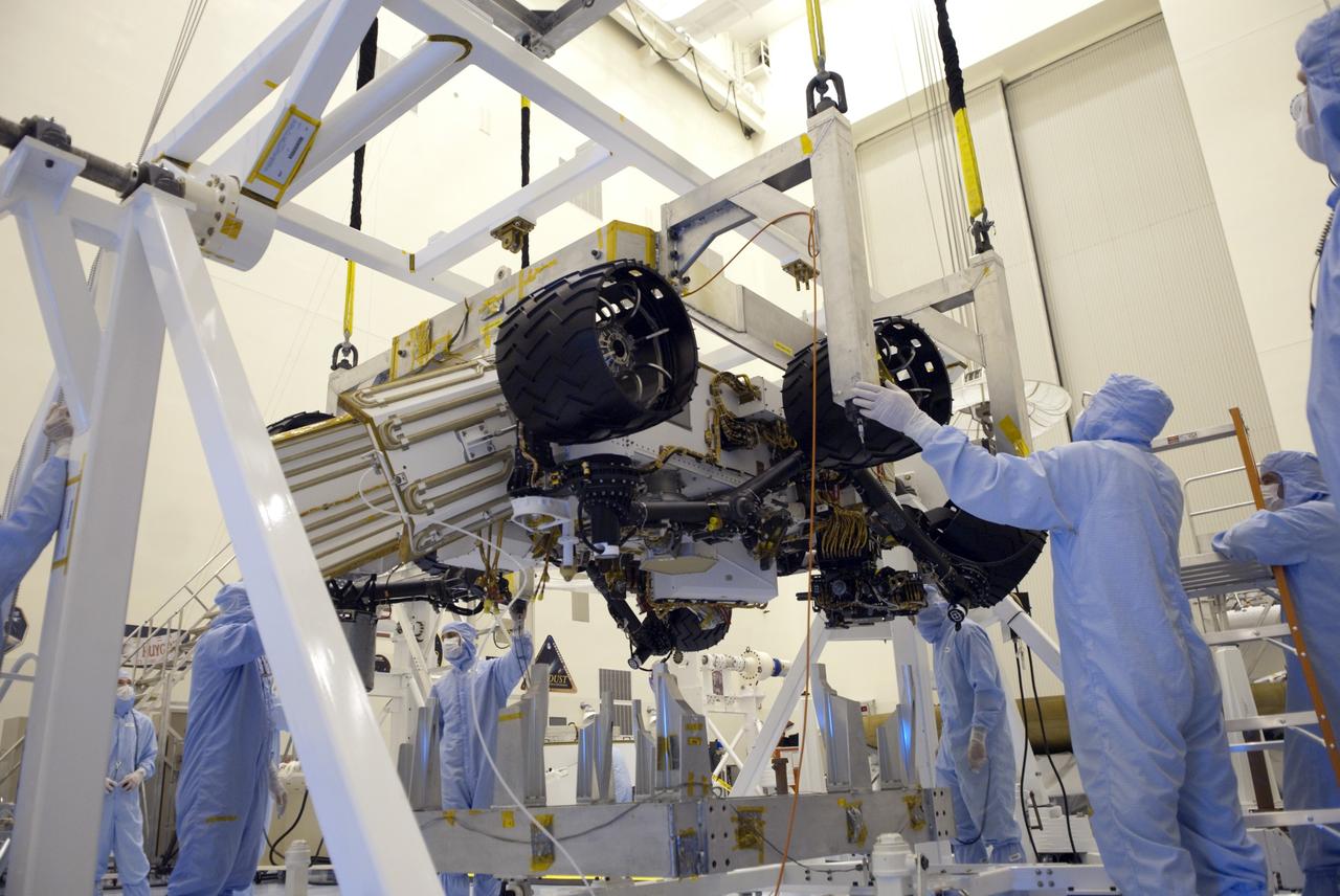 CAPE CANAVERAL, Fla. -- Technicians, using an overhead crane in the Payload Hazardous Servicing Facility at NASA's Kennedy Space Center in Florida, lift and secure NASA's Mars Science Laboratory (MSL) rover, known as Curiosity, to a rotation fixture for testing. A United Launch Alliance Atlas V-541 configuration will be used to loft MSL into space. Curiosity’s 10 science instruments are designed to search for evidence on whether Mars has had environments favorable to microbial life, including chemical ingredients for life. The unique rover will use a laser to look inside rocks and release its gasses so that the rover’s spectrometer can analyze and send the data back to Earth. MSL is scheduled to launch from Cape Canaveral Air Force Station in Florida Nov. 25 with a window extending to Dec. 18 and arrival at Mars Aug. 2012. For more information, visit http://www.nasa.gov/msl. Photo credit: NASA/Jim Grossmann