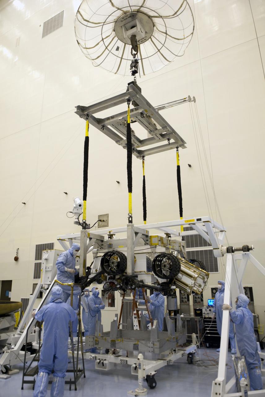 CAPE CANAVERAL, Fla. -- Technicians, using an overhead crane in the Payload Hazardous Servicing Facility at NASA's Kennedy Space Center in Florida, lift and secure NASA's Mars Science Laboratory (MSL) rover, known as Curiosity, to a rotation fixture for testing. A United Launch Alliance Atlas V-541 configuration will be used to loft MSL into space. Curiosity’s 10 science instruments are designed to search for evidence on whether Mars has had environments favorable to microbial life, including chemical ingredients for life. The unique rover will use a laser to look inside rocks and release its gasses so that the rover’s spectrometer can analyze and send the data back to Earth. MSL is scheduled to launch from Cape Canaveral Air Force Station in Florida Nov. 25 with a window extending to Dec. 18 and arrival at Mars Aug. 2012. For more information, visit http://www.nasa.gov/msl. Photo credit: NASA/Jim Grossmann