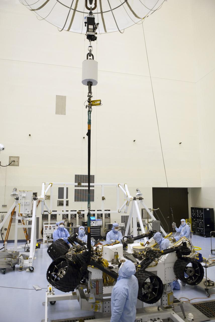 CAPE CANAVERAL, Fla. -- Technicians in the Payload Hazardous Servicing Facility at NASA's Kennedy Space Center in Florida complete rotation tests on NASA's Mars Science Laboratory (MSL) rover, known as Curiosity, and lower it towards a rolling work stand. There, the wheels will undergo deployment testing. A United Launch Alliance Atlas V-541 configuration will be used to loft MSL into space. Curiosity’s 10 science instruments are designed to search for evidence on whether Mars has had environments favorable to microbial life, including chemical ingredients for life. The unique rover will use a laser to look inside rocks and release its gasses so that the rover’s spectrometer can analyze and send the data back to Earth. MSL is scheduled to launch from Cape Canaveral Air Force Station in Florida Nov. 25 with a window extending to Dec. 18 and arrival at Mars Aug. 2012. For more information, visit http://www.nasa.gov/msl. Photo credit: NASA/Jim Grossmann