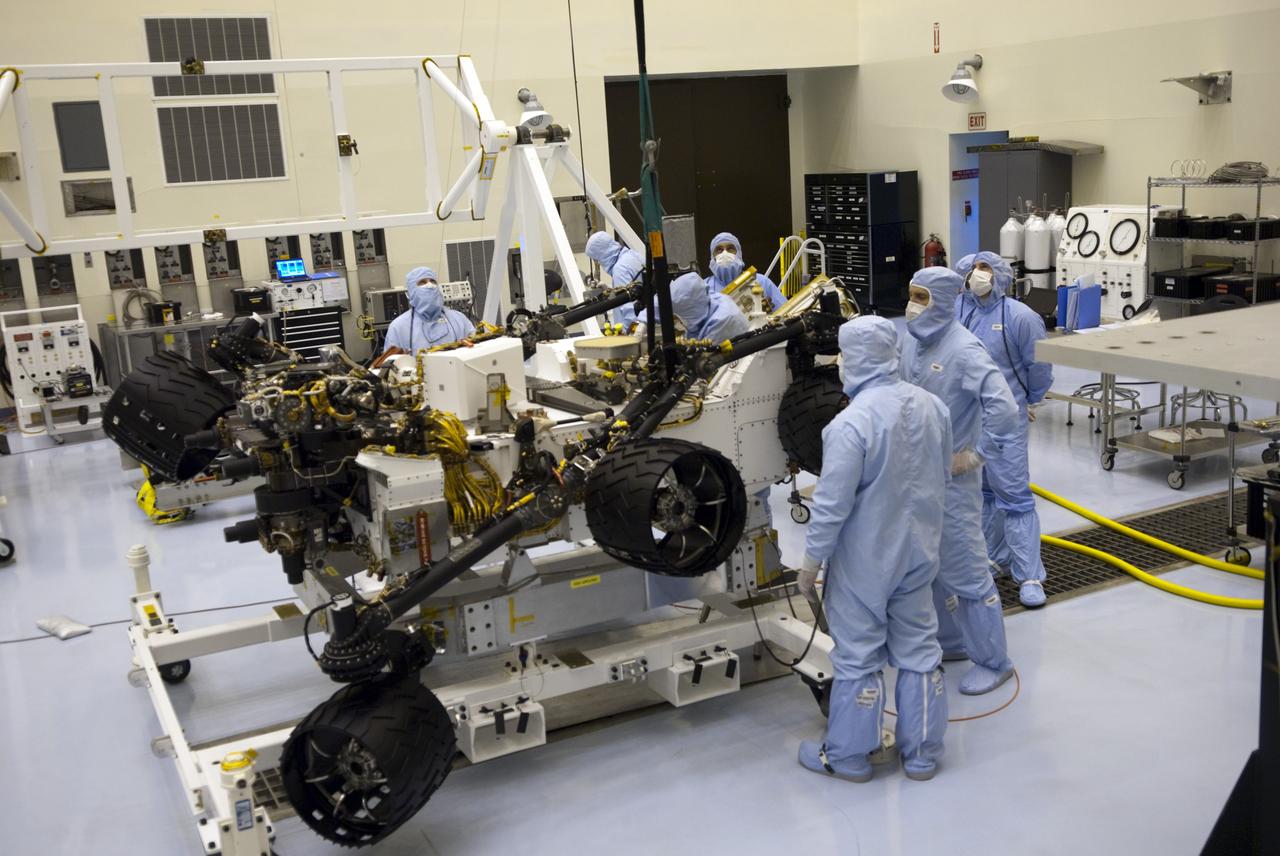 CAPE CANAVERAL, Fla. -- Technicians in the Payload Hazardous Servicing Facility at NASA's Kennedy Space Center in Florida complete rotation tests on NASA's Mars Science Laboratory (MSL) rover, known as Curiosity. Here, the wheels undergo deployment testing. A United Launch Alliance Atlas V-541 configuration will be used to loft MSL into space. Curiosity’s 10 science instruments are designed to search for evidence on whether Mars has had environments favorable to microbial life, including chemical ingredients for life. The unique rover will use a laser to look inside rocks and release its gasses so that the rover’s spectrometer can analyze and send the data back to Earth. MSL is scheduled to launch from Cape Canaveral Air Force Station in Florida Nov. 25 with a window extending to Dec. 18 and arrival at Mars Aug. 2012. For more information, visit http://www.nasa.gov/msl. Photo credit: NASA/Jim Grossmann