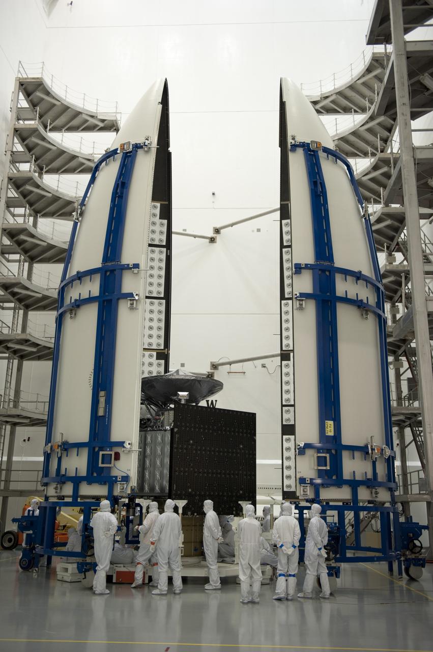 CAPE CANAVERAL, Fla. -- In the Astrotech payload processing facility near Kennedy Space Center in Florida, the Juno spacecraft is carefully positioned into half of the Atlas payload fairing during work to enclose the spacecraft for launch. The fairing will protect the spacecraft from the impact of aerodynamic pressure and heating during ascent and will be jettisoned once the spacecraft is outside the Earth's atmosphere. Juno is scheduled to launch aboard a United Launch Alliance Atlas V rocket from Cape Canaveral, Fla., Aug. 5.The solar-powered spacecraft will orbit Jupiter's poles 33 times to find out more about the gas giant's origins, structure, atmosphere and magnetosphere and investigate the existence of a solid planetary core. For more information, visit www.nasa.gov/juno. Photo credit: NASA/Kim Shiflett