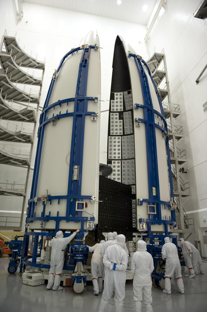CAPE CANAVERAL, Fla. -- In the Astrotech payload processing facility near Kennedy Space Center in Florida, the second half of the Atlas payload fairing is carefully positioned around the Juno spacecraft during work to enclose the spacecraft for launch.    The fairing will protect the spacecraft from the impact of aerodynamic pressure and heating during ascent and will be jettisoned once the spacecraft is outside the Earth's atmosphere. Juno is scheduled to launch aboard a United Launch Alliance Atlas V rocket from Cape Canaveral, Fla., Aug. 5.The solar-powered spacecraft will orbit Jupiter's poles 33 times to find out more about the gas giant's origins, structure, atmosphere and magnetosphere and investigate the existence of a solid planetary core. For more information, visit www.nasa.gov/juno. Photo credit: NASA/Kim Shiflett