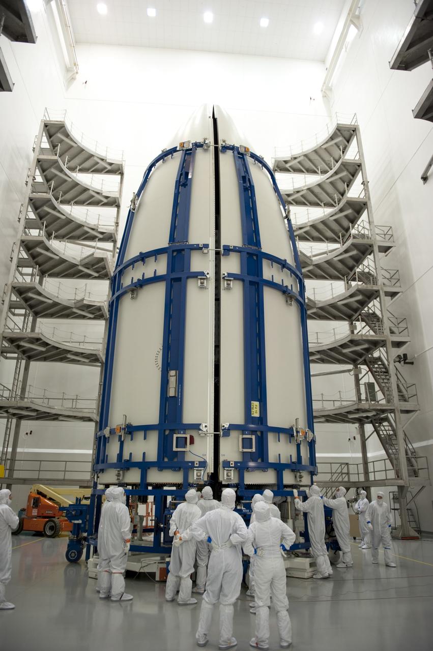 CAPE CANAVERAL, Fla. -- In the Astrotech payload processing facility near Kennedy Space Center in Florida, the Atlas payload fairing obscures the Juno spacecraft from view as the fairing closes around the spacecraft for launch.    The fairing will protect the spacecraft from the impact of aerodynamic pressure and heating during ascent and will be jettisoned once the spacecraft is outside the Earth's atmosphere. Juno is scheduled to launch aboard a United Launch Alliance Atlas V rocket from Cape Canaveral, Fla., Aug. 5.The solar-powered spacecraft will orbit Jupiter's poles 33 times to find out more about the gas giant's origins, structure, atmosphere and magnetosphere and investigate the existence of a solid planetary core. For more information, visit www.nasa.gov/juno. Photo credit: NASA/Kim Shiflett