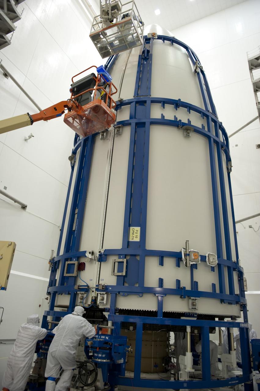 CAPE CANAVERAL, Fla. -- In the Astrotech payload processing facility near Kennedy Space Center in Florida, spacecraft technicians secure the Atlas payload fairing around the Juno spacecraft for launch.    The fairing will protect the spacecraft from the impact of aerodynamic pressure and heating during ascent and will be jettisoned once the spacecraft is outside the Earth's atmosphere. Juno is scheduled to launch aboard a United Launch Alliance Atlas V rocket from Cape Canaveral, Fla., Aug. 5.The solar-powered spacecraft will orbit Jupiter's poles 33 times to find out more about the gas giant's origins, structure, atmosphere and magnetosphere and investigate the existence of a solid planetary core. For more information, visit www.nasa.gov/juno. Photo credit: NASA/Kim Shiflett