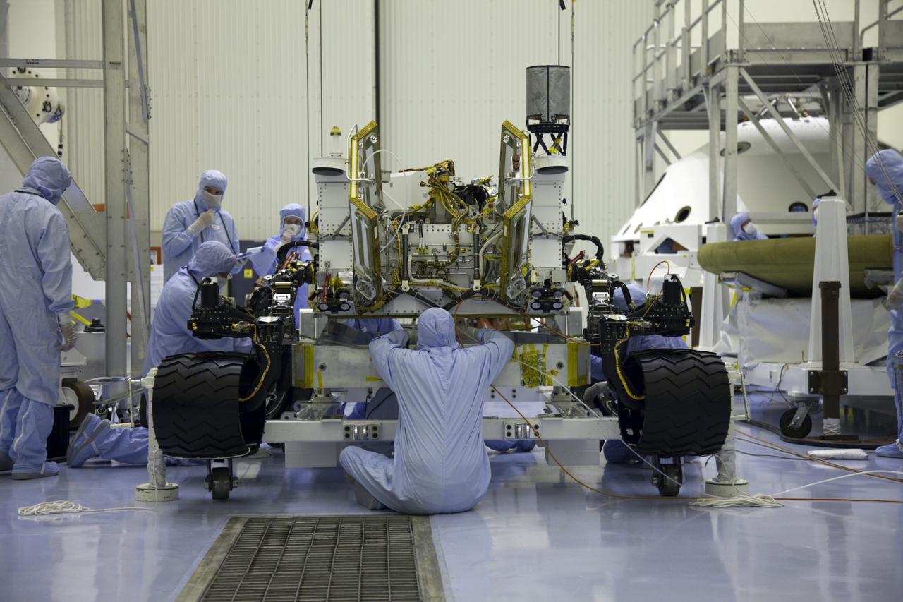 Cape Canaveral, Fla. -- Technicians at the Payload Hazardous Servicing Facility at NASA's Kennedy Space Center in Florida, prepare to move NASA's Mars Science Laboratory (MSL) rover, known as Curiosity, to the high bay floor where the instrument mast and science boom will undergo deployment testing. A United Launch Alliance Atlas V-541 configuration will be used to loft MSL into space. Curiosity’s 10 science instruments are designed to search for evidence on whether Mars has had environments favorable to microbial life, including chemical ingredients for life. The unique rover will use a laser to look inside rocks and release its gasses so that the rover’s spectrometer can analyze and send the data back to Earth. MSL is scheduled to launch from Cape Canaveral Air Force Station in Florida Nov. 25 with a window extending to Dec. 18 and arrival at Mars Aug. 2012. For more information, visit http://www.nasa.gov/msl. Photo credit: NASA/Frankie Martin